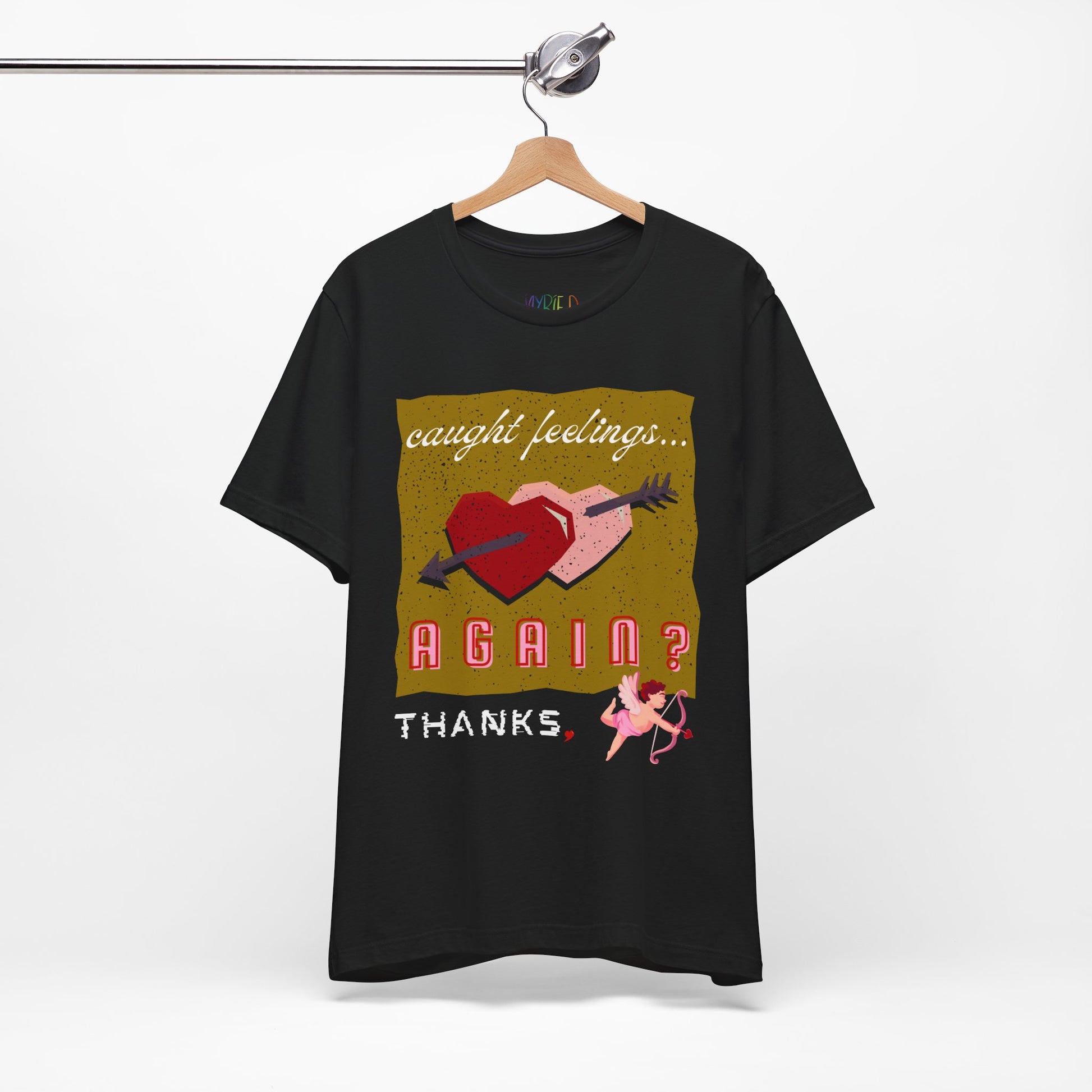 Black t-shirt with double heart graphic design and text 'Caught Feelings AGAIN? Thanks,' followed by a picture of cupid