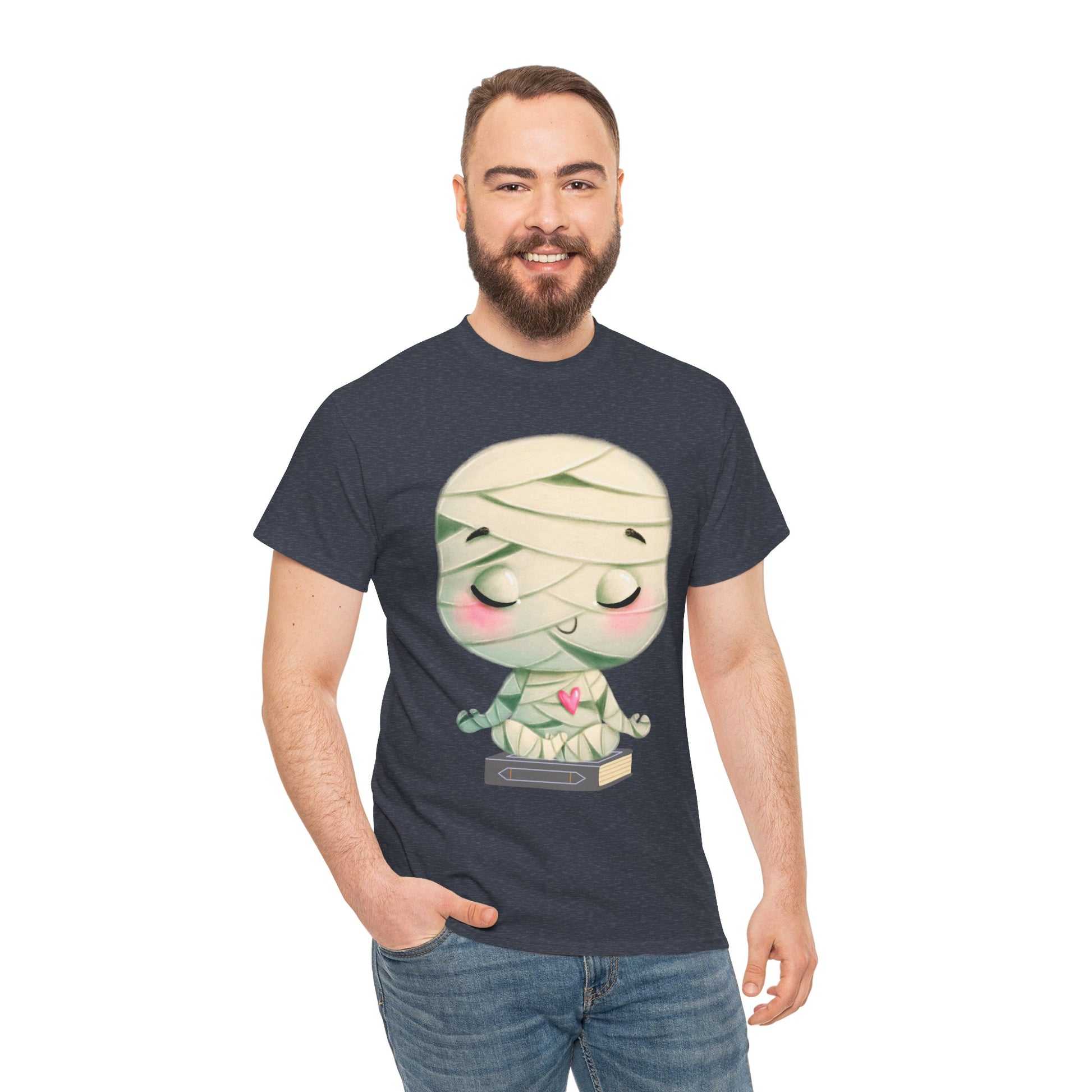 Man wearing a heather navy t-shirt with a cartoon mummy in a meditation pose, sitting on a book