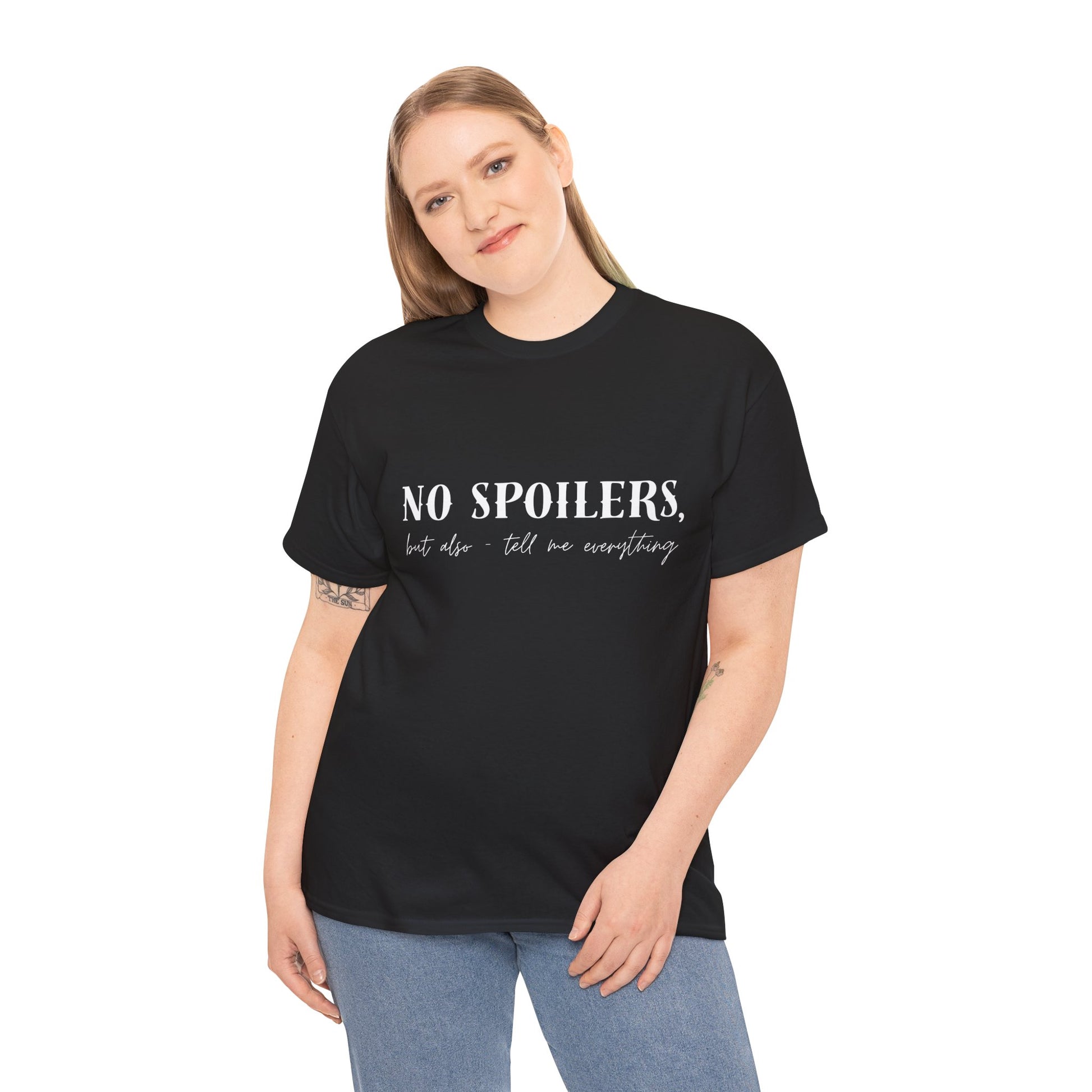 Woman wearing a black t-shirt with white text 'NO SPOILERS, but also tell me everything' 