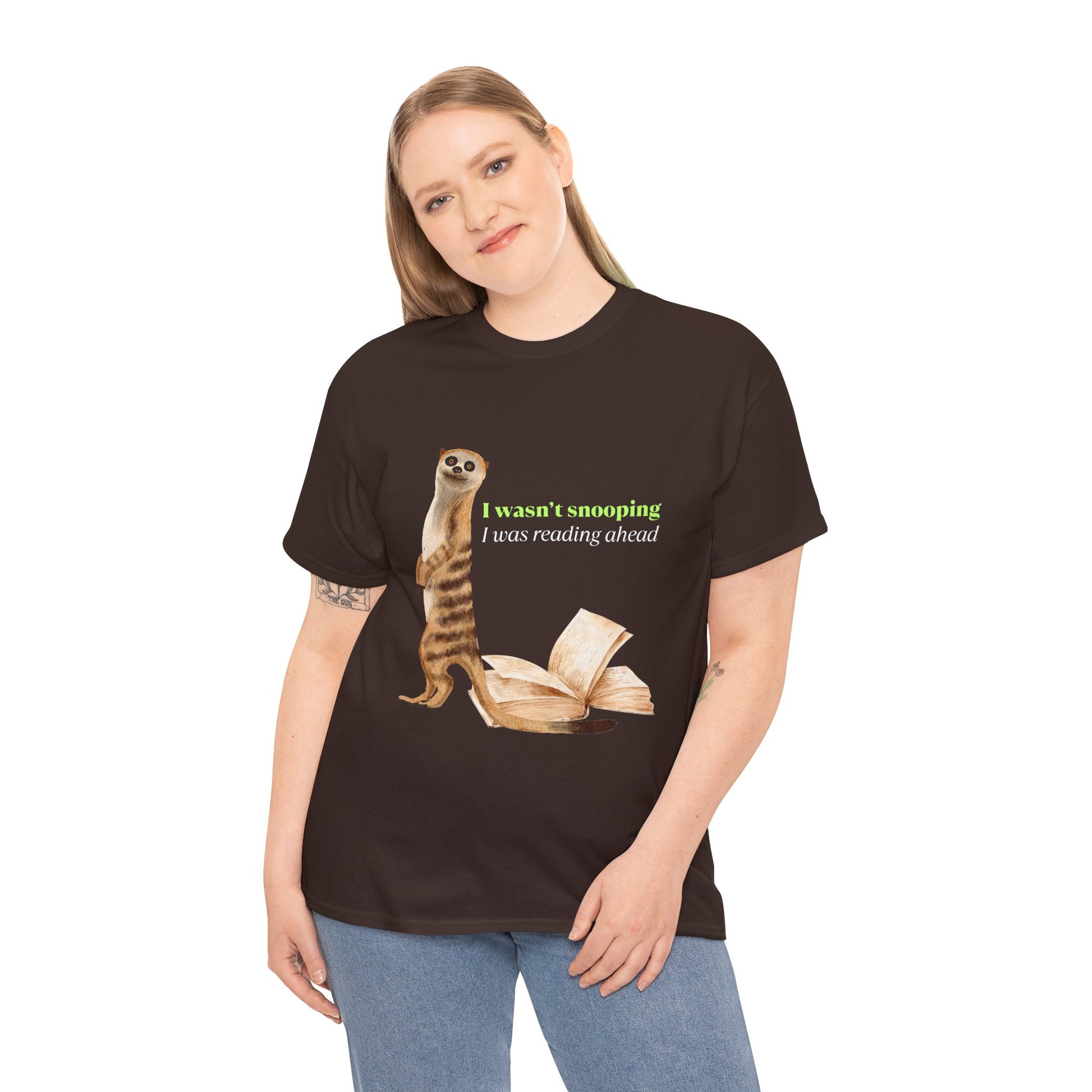 Woman wearing a brown t-shirt with a sheepish meerkat, back to an open book, text 'I Wasn't Snooping, I Was Reading Ahead'