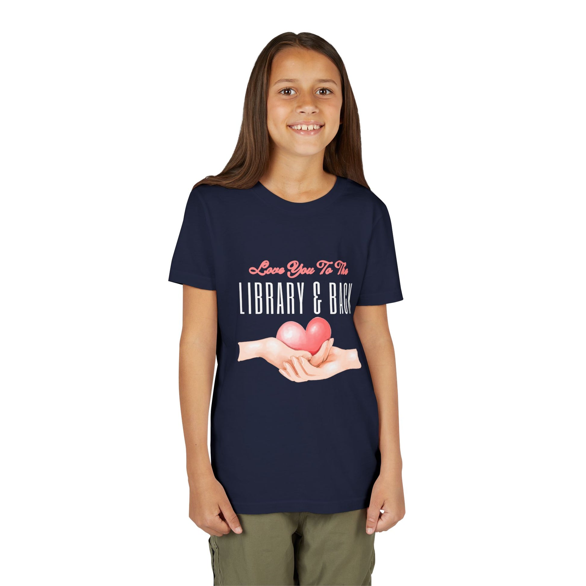 Girl wearing a navy blue t-shirt with a graphic of hands holding a heart and text 'Love You To The Library & Back' 