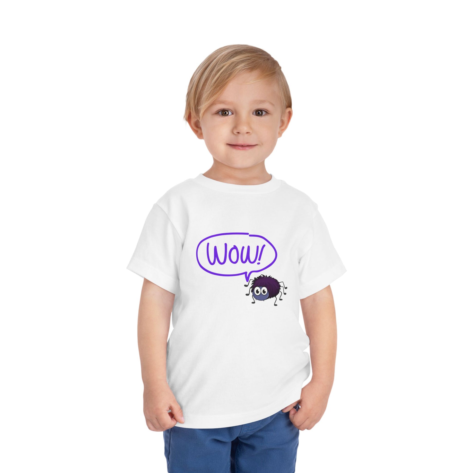 Toddler wearing a white t-shirt with a purple spider and a 'WOW!' thought bubble