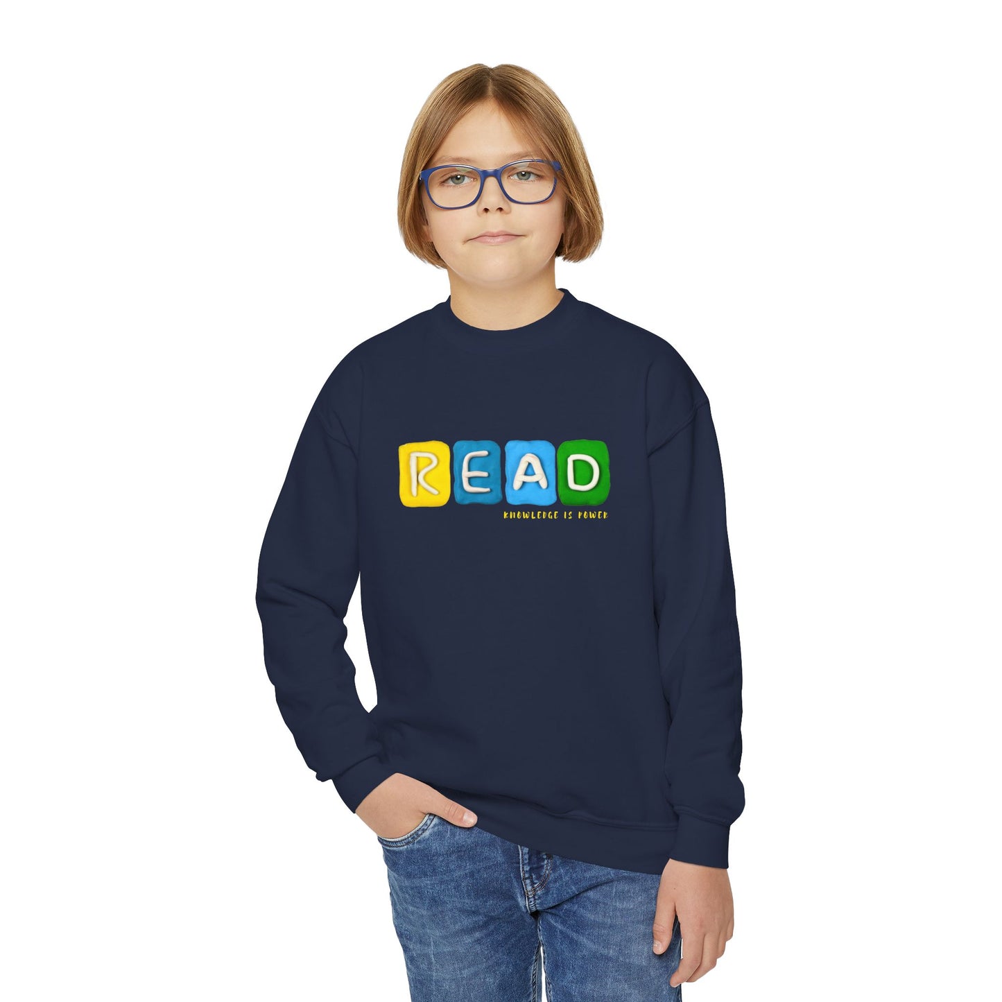 Boy wearing a navy blue sweatshirt with colorful clay sculpted to spell 'READ'