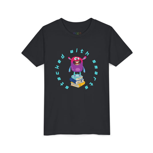 Black t-shirt with a colorful, toothy monster graphic standing on a stack of books, circled by text 'STACKED WITH SMARTS'