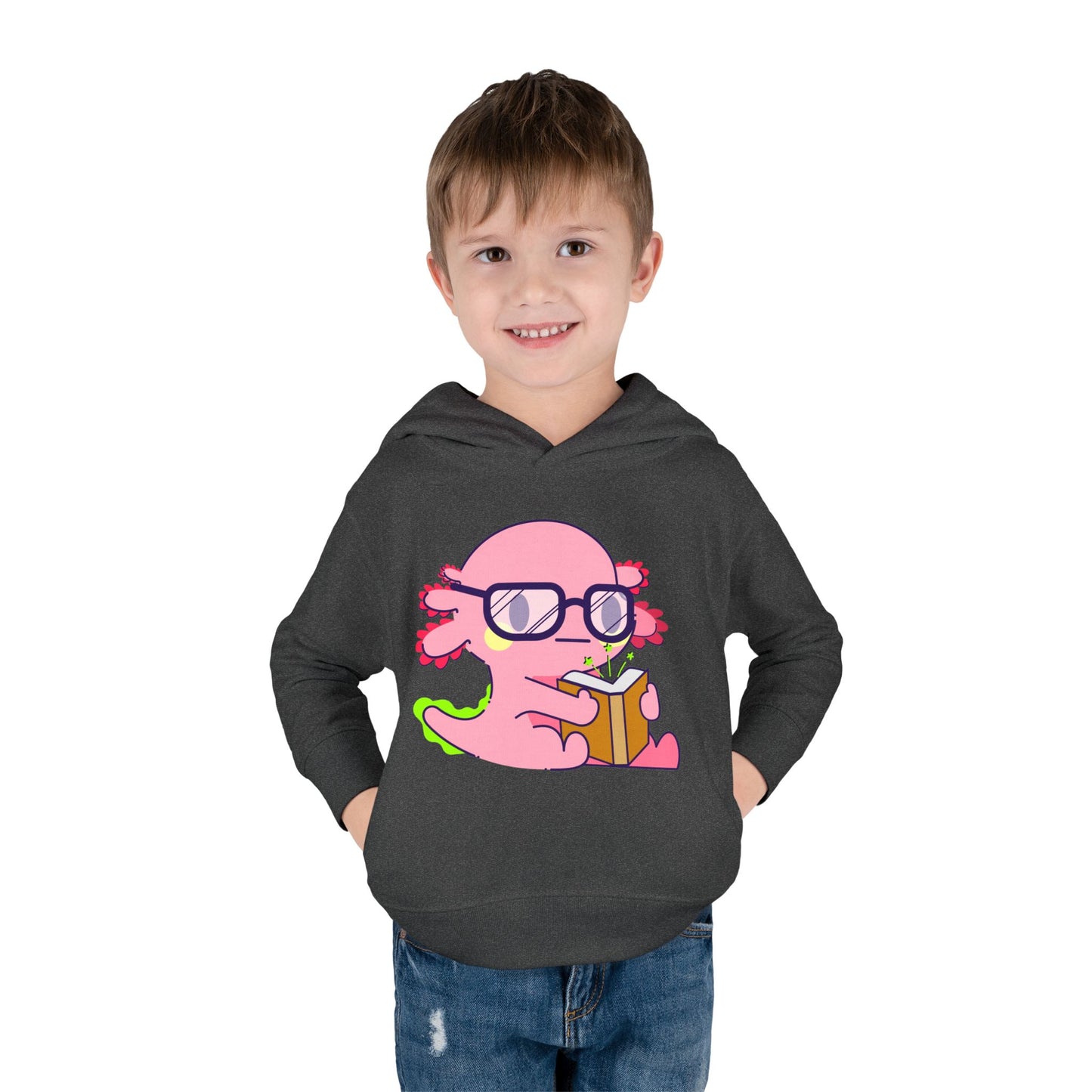 boy wearing a dark gray toddler hoodie with a pink axolotl holding a book and wearing glasses 