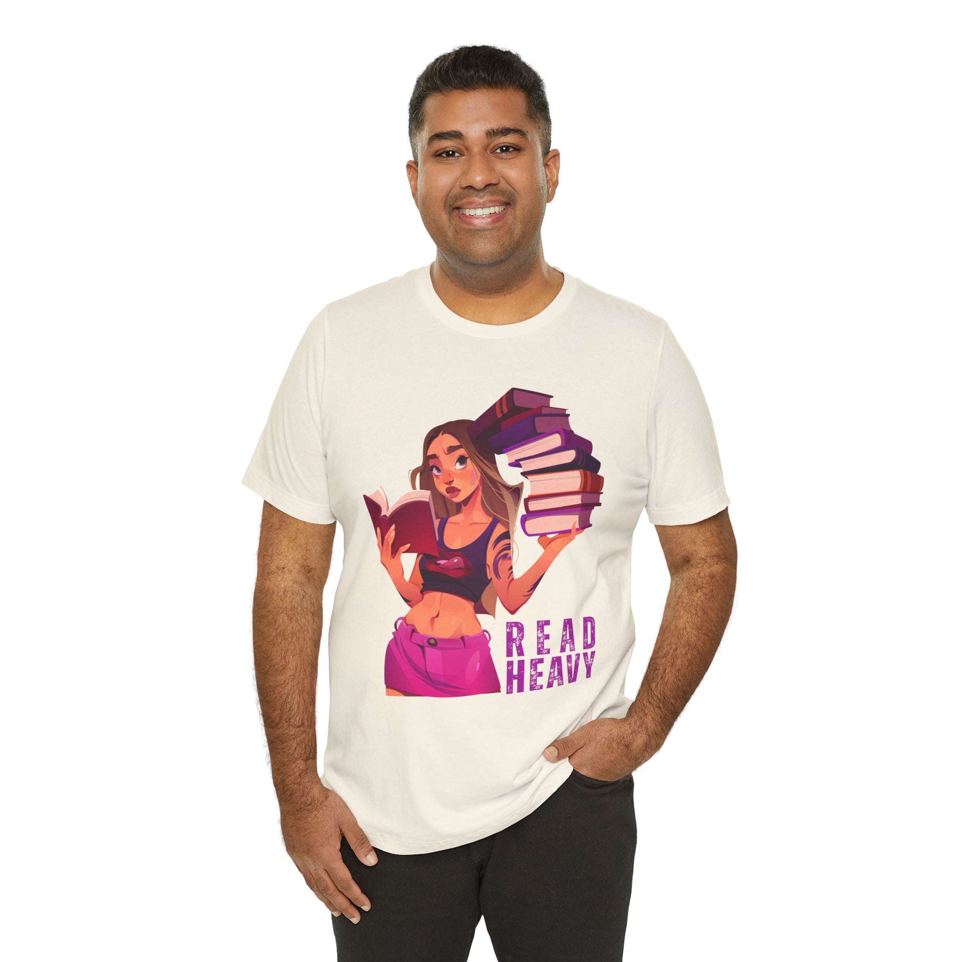Man wearing a beige t-shirt with a stylish woman graphic reading a book in one hand and holding a stack of books in the other, and the text 'Read Heavy' 