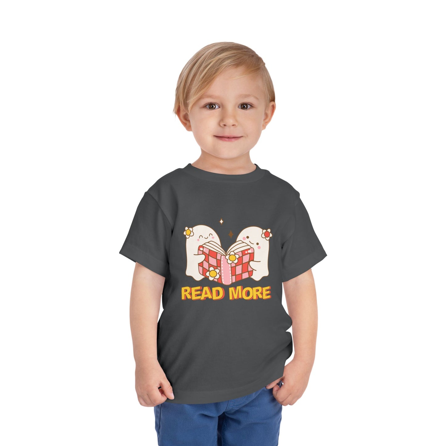 Toddler wearing a gray t-shirt with cartoon ghosts reading a shared book and 'Read More' text 