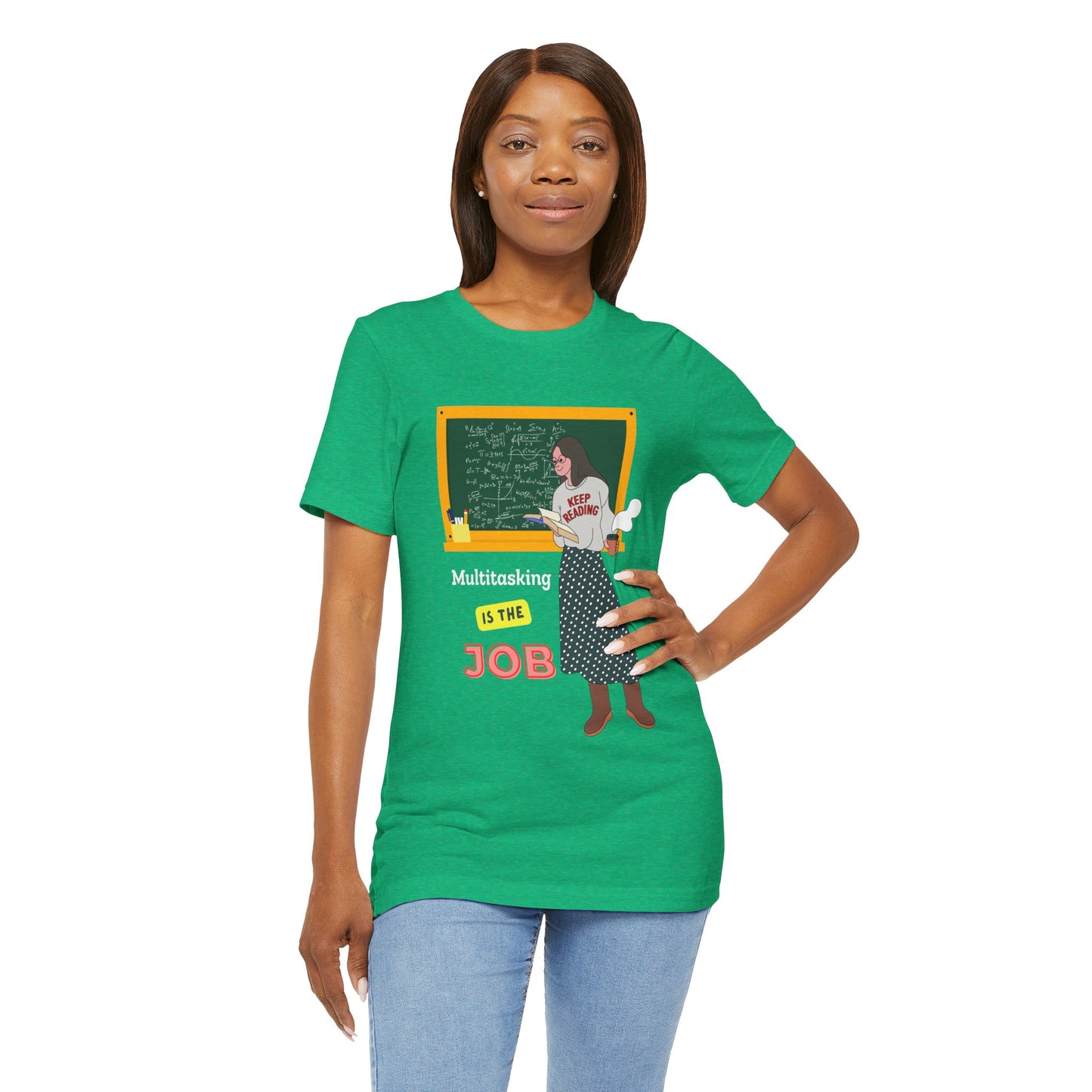 Woman wearing a green t-shirt with a graphic design of a woman at a chalkboard, an open book in one hand and steaming coffee in the other, text 'Multitasking is the Job' 