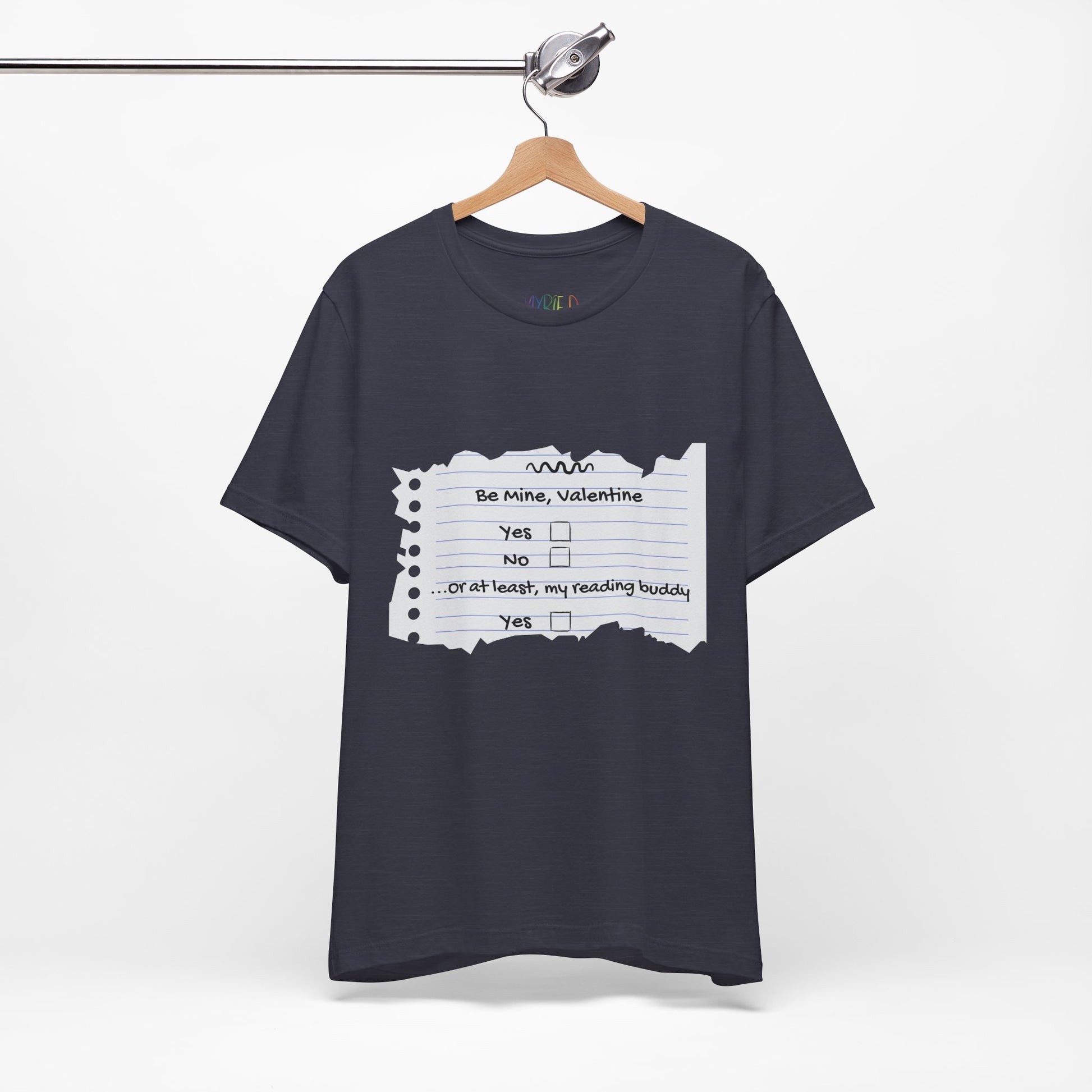 Navy blue t-shirt with an image of torn notebook paper and old school checkboxes depicting 'Be Mine Valentine, Yes, No' and 'Or At Least , My Reading Buddy, Yes'