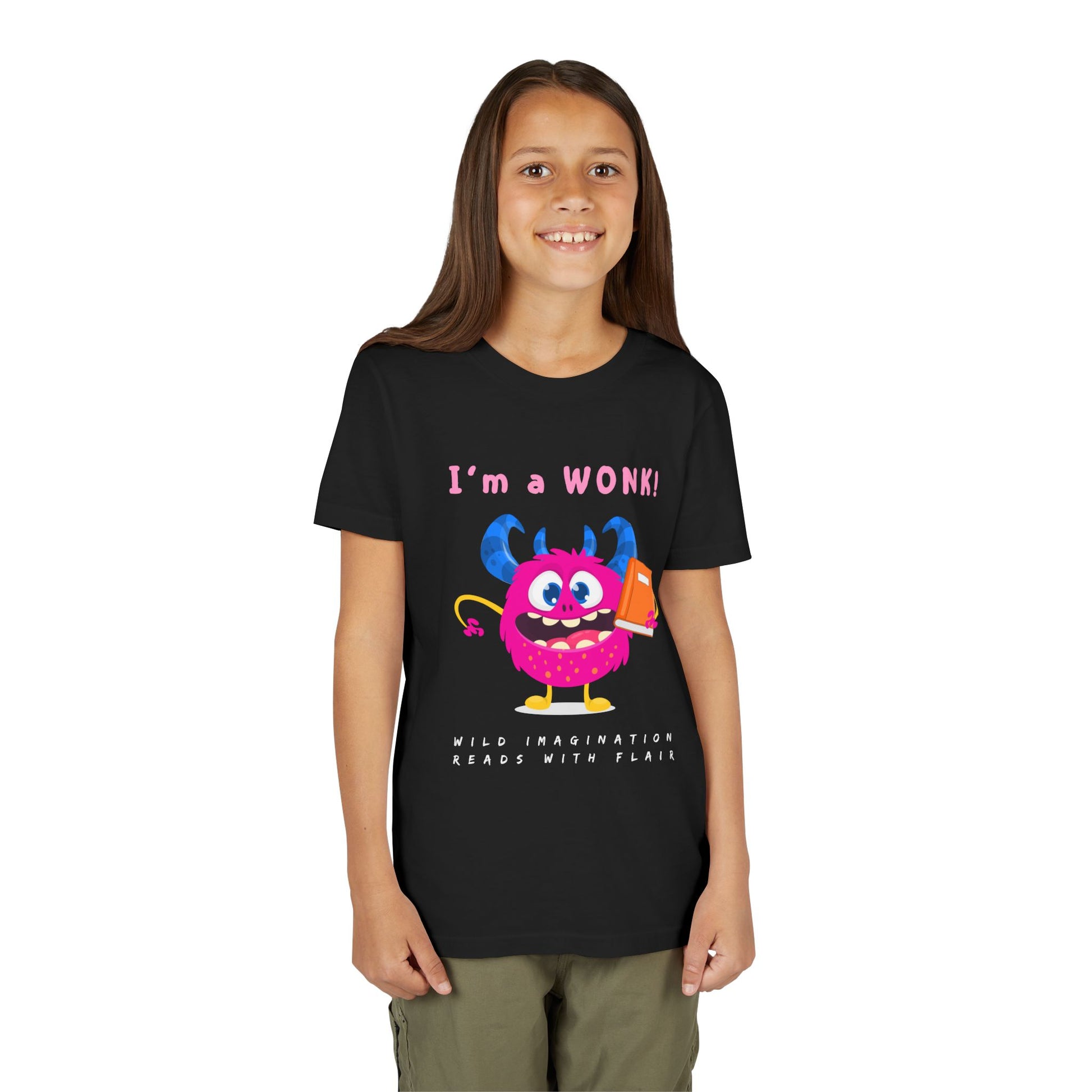 Girl wearing a black personality t-shirt with a colorful pink monster graphic holding a book and proudly stating 'I'm a WONK!'