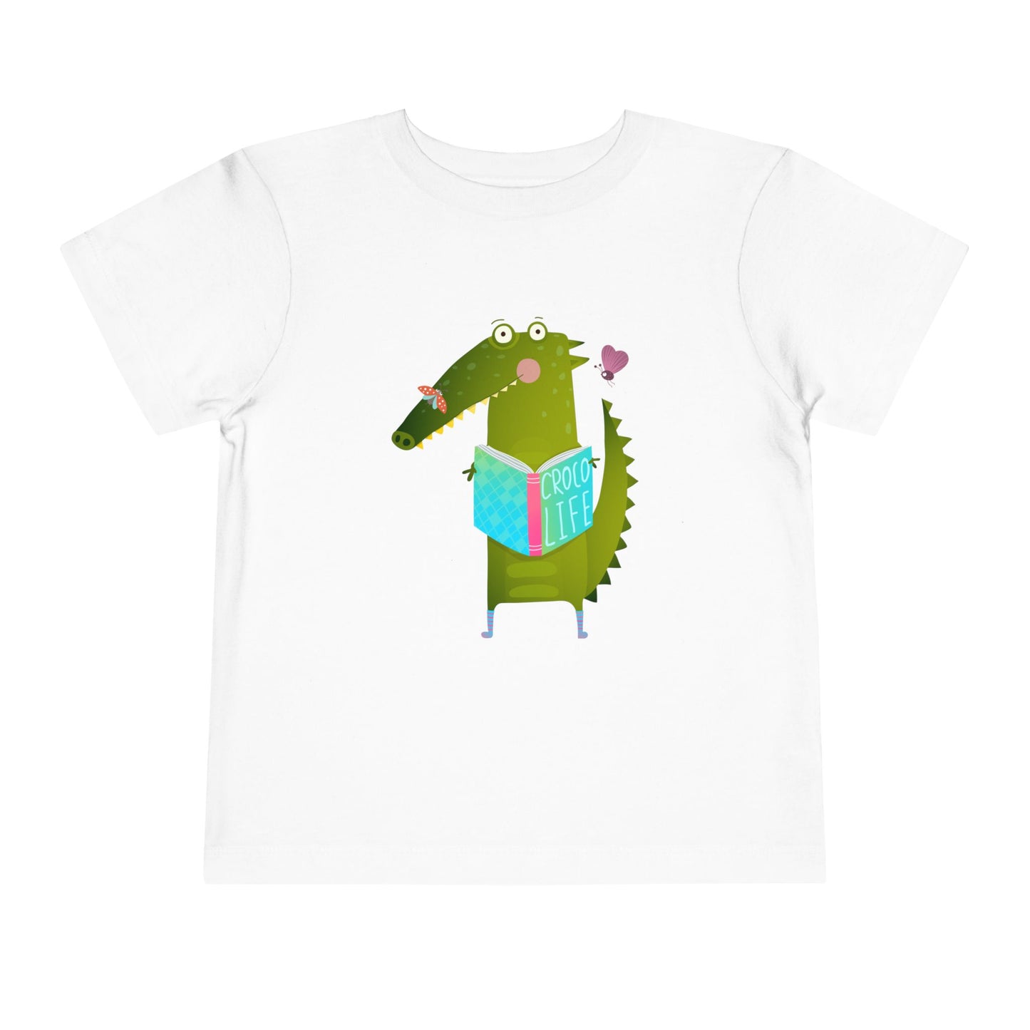 White t-shirt with a cartoon crocodile reading a Croc Life book amongst sweet insects 