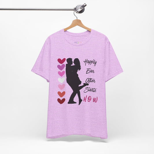 Light purple t-shirt with a black graphic design of two people embracing between stacked hearts and text 'Happily Ever After Starts Now'