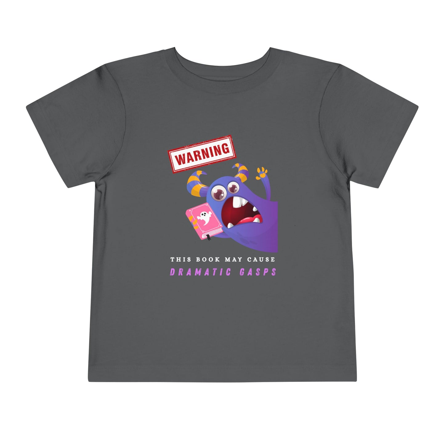 Gray toddler t-shirt with an open mouth purple monster holding a pink book and a WARNING ' This Book May Cause Dramatic Gasps'