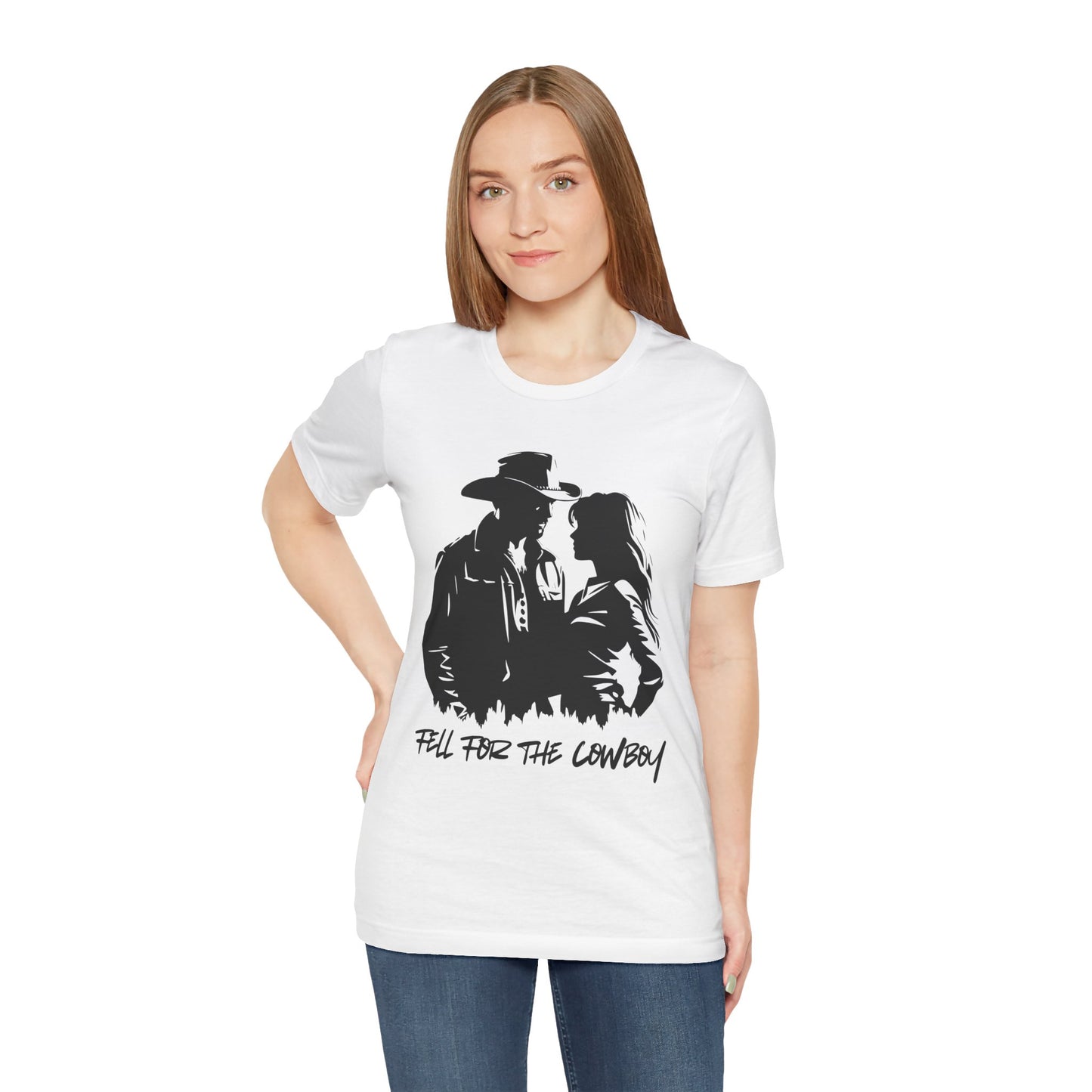 Woman wearing a white t-shirt with black graphic of a man and a woman, text says 'Fell for the Cowboy'