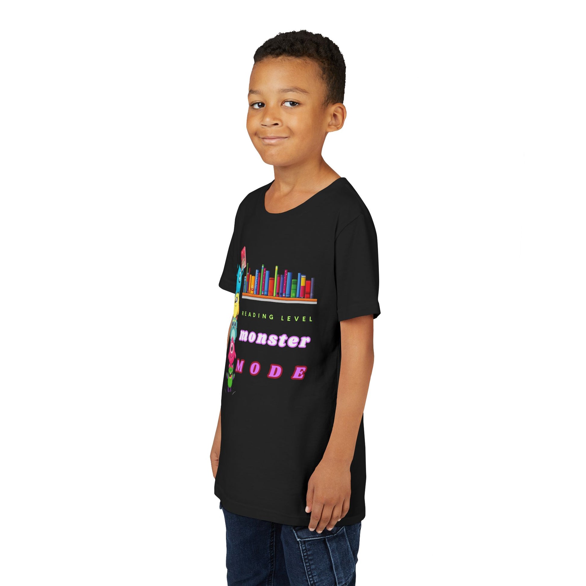 Boy wearing a black t-shirt with colorful monsters standing on each others shoulders to reach a book on the bookshelf and text 'Reading Level Monster Mode'