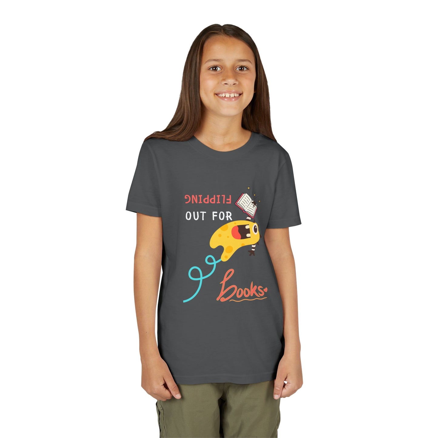 Girl wearing a gray t-shirt with a yellow monster holding a book while flipping backwards through the air and playful text 'Flipping Out For Books'