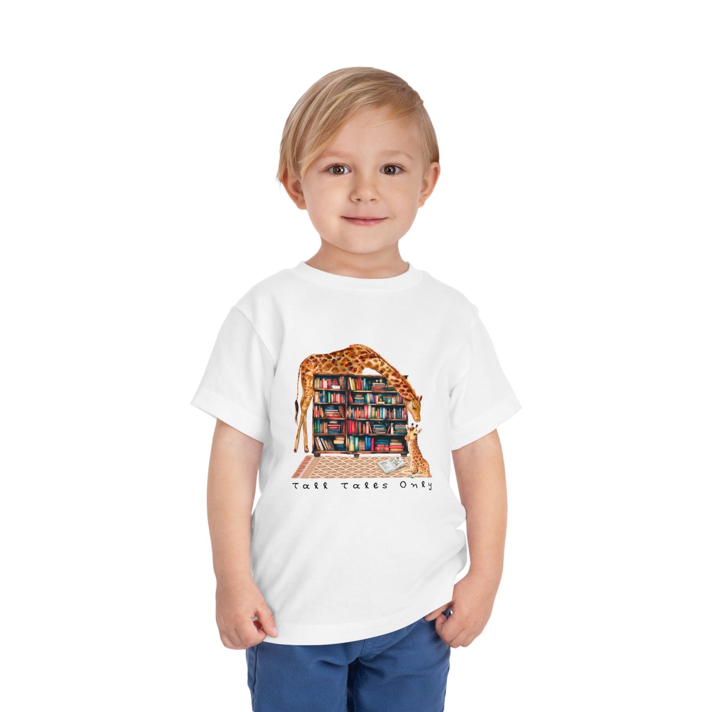 Child wearing a white toddler t-shirt with a mama giraffe leaning over library bookshelves to check on her little one and text 'Tall Tales Only'