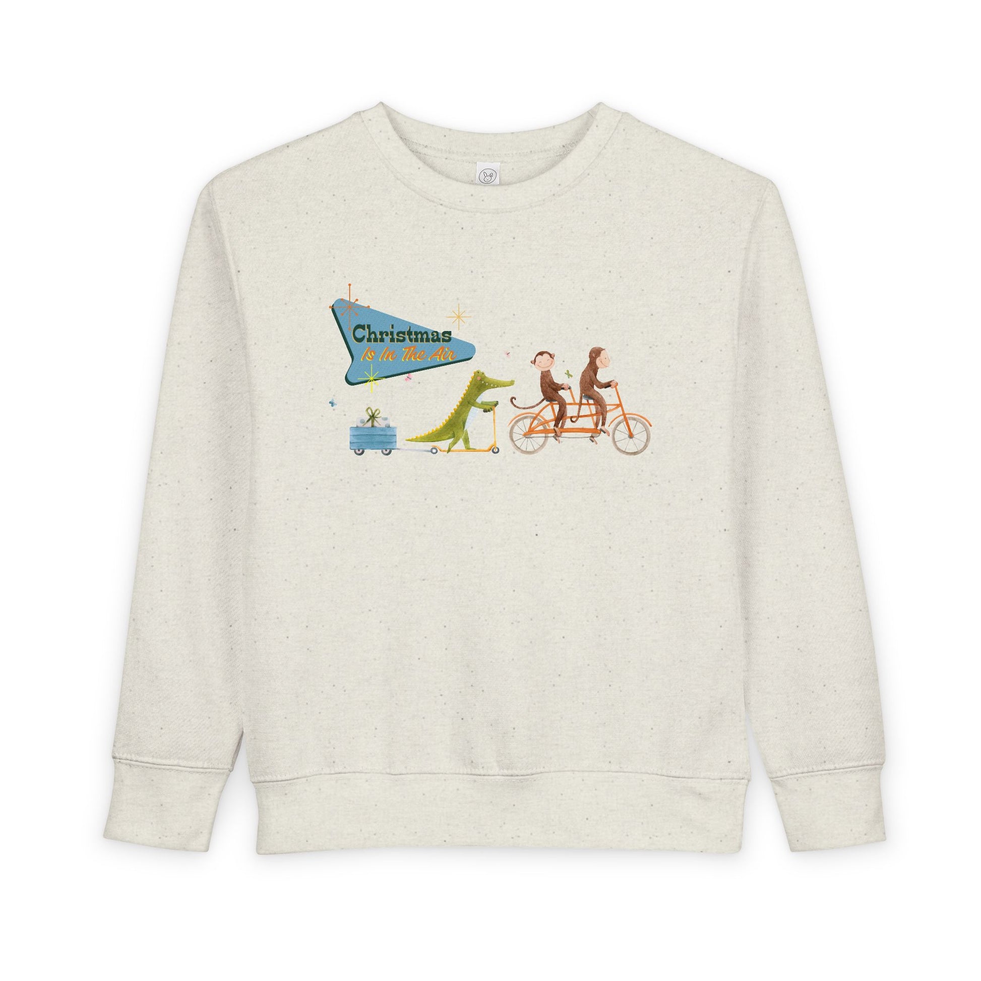 Beige toddler sweatshirt with a graphic design of two monkeys riding a tandem bike, followed by a crocodile on a scooter pulling a trailer with a present, text 'Christmas Is In The Air' 