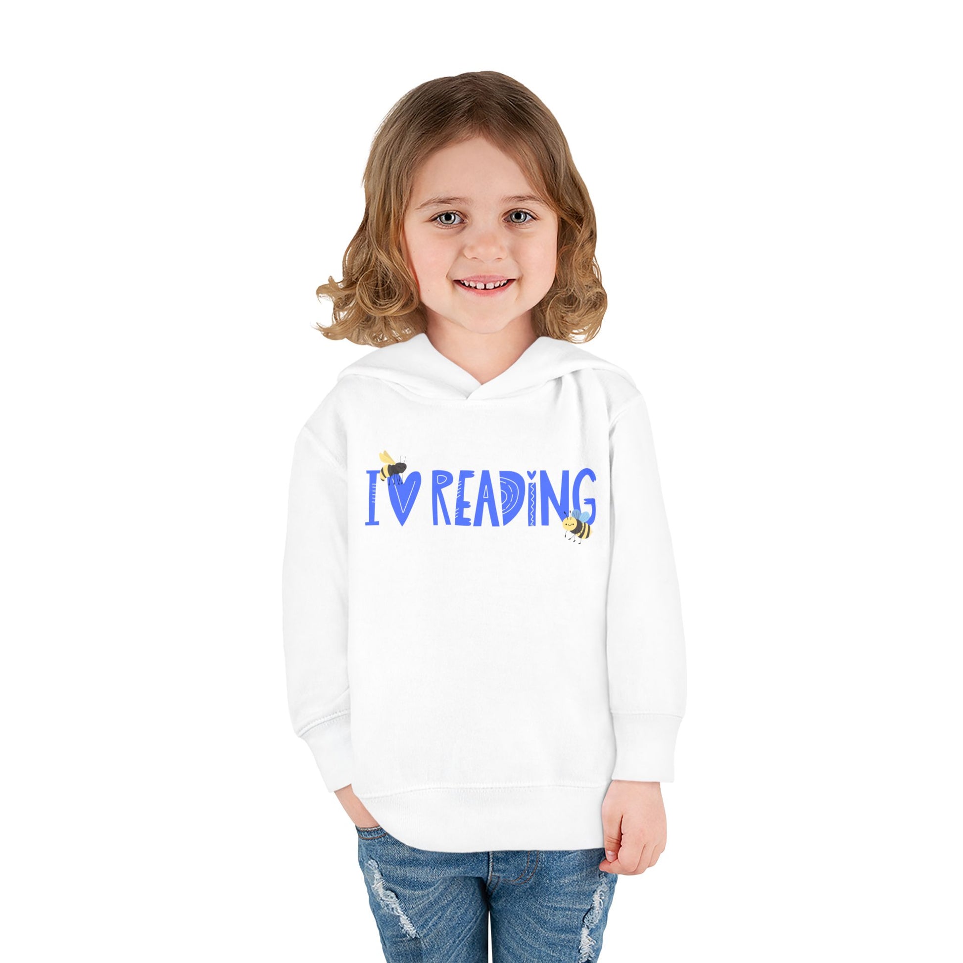 Girl wearing a white toddler hoodie with blue 'I Love Reading' text and two bumblebees