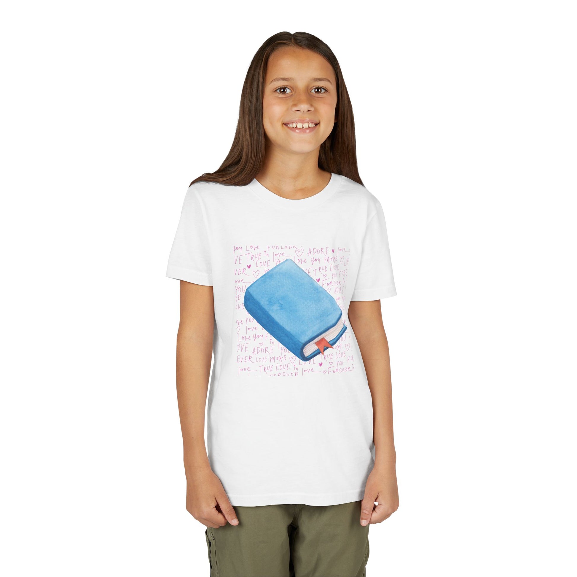 Girl wearing a white t-shirt with a pink hand writing and a blue book graphic 