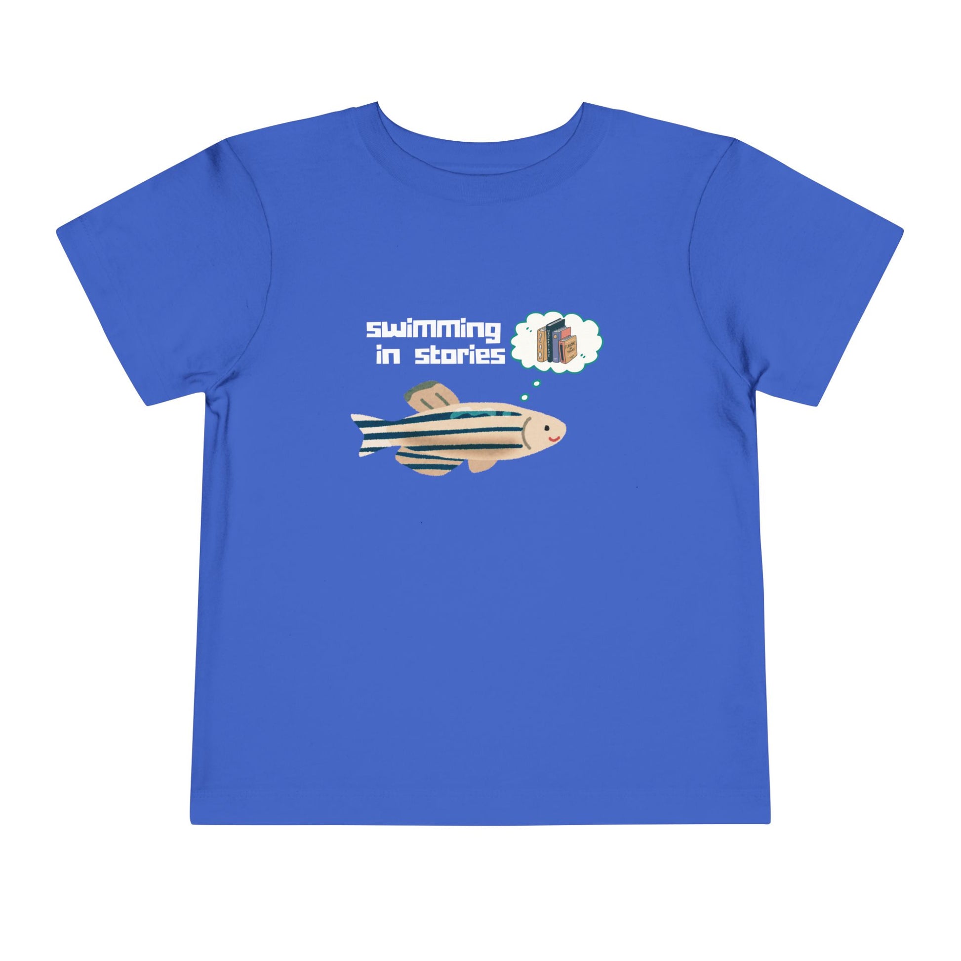 Blue t-shirt with a fish graphic, thought bubble picturing books, and text 'swimming in stories' 