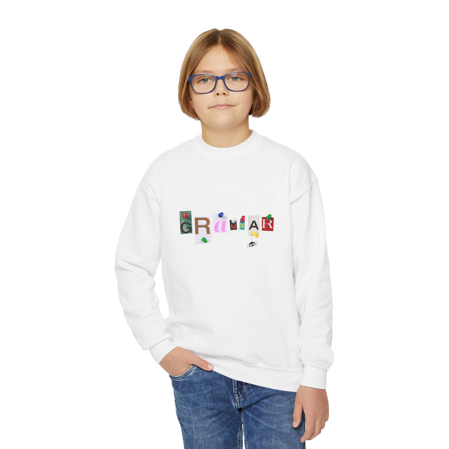Boy wearing a white sweatshirt with colorful letters tacked up to spell 'Grammar'
