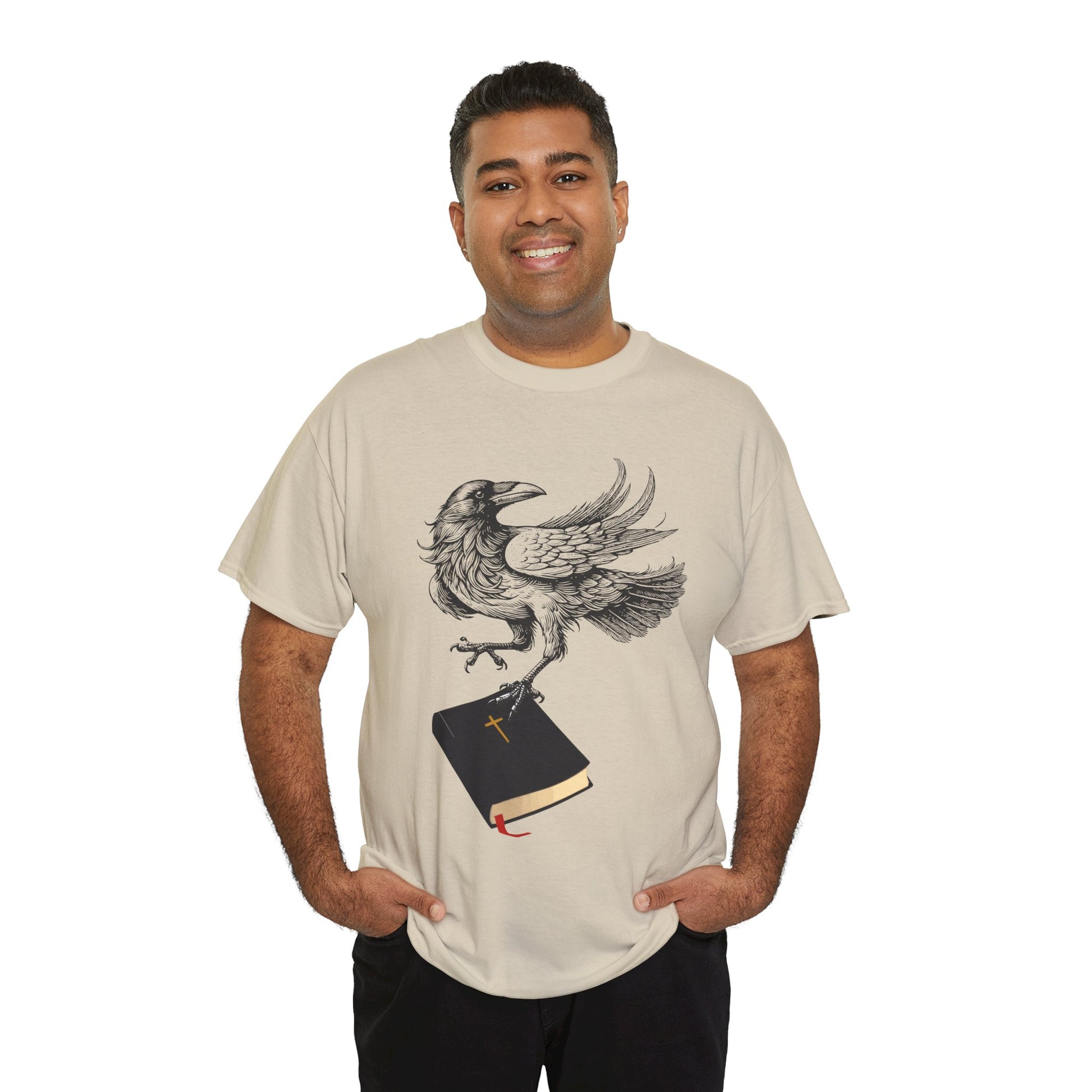 Man wearing a tan t-shirt with a crow carying a bible, a shirt on a hanger against a white background