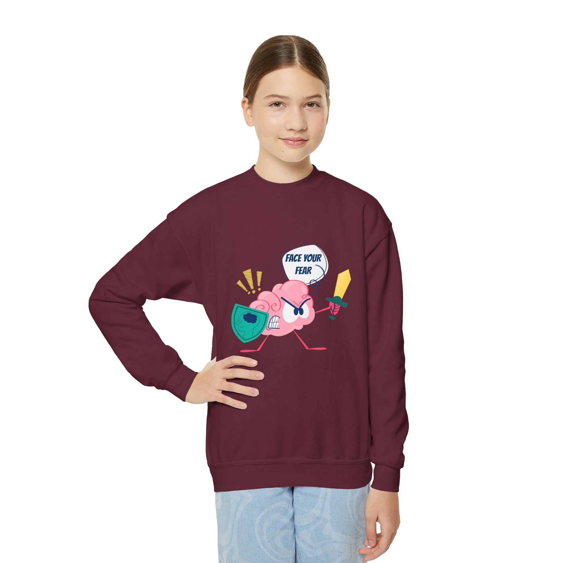 Girl wearing a maroon sweatshirt with a cartoon brain holding a shield and sword, text 'Face Your Fear' 