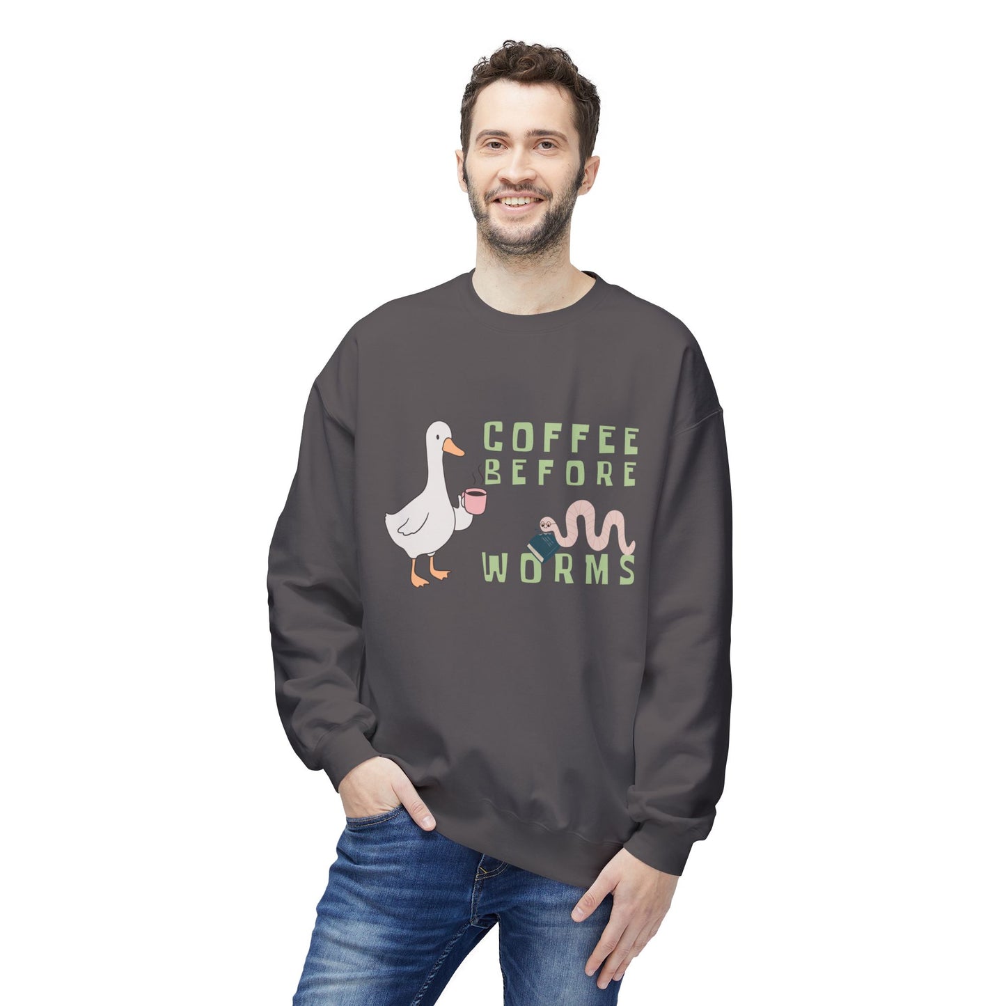 Man wearing a gray sweatshirt with a graphic of a duck holding a coffee cup and text 'Coffee Before Worms' 
