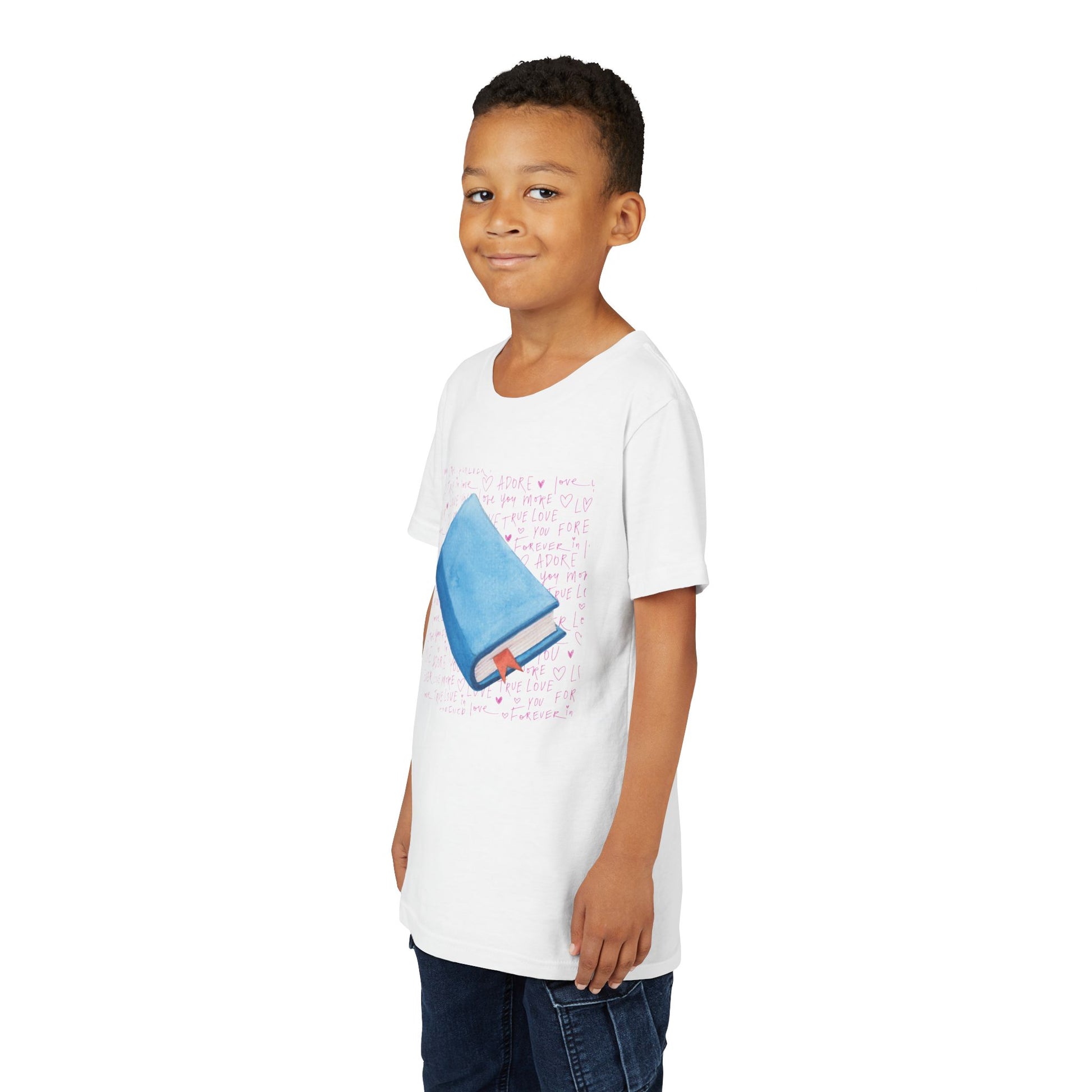 Boy wearing a white t-shirt with a pink hand writing and a blue book graphic 