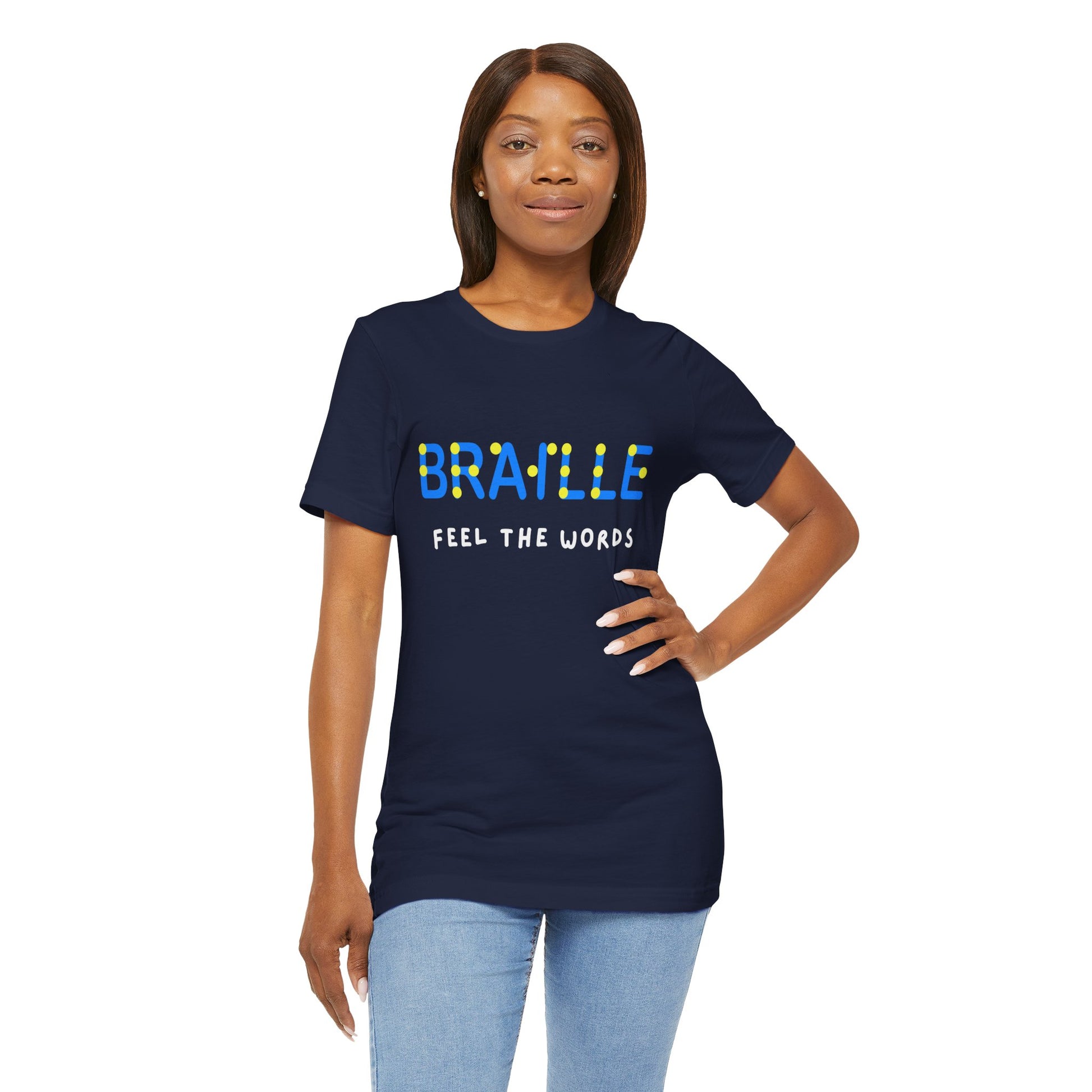 Woman wearing a navy blue t-shirt with blue, yellow and white text 'Braille Feel the Words' 