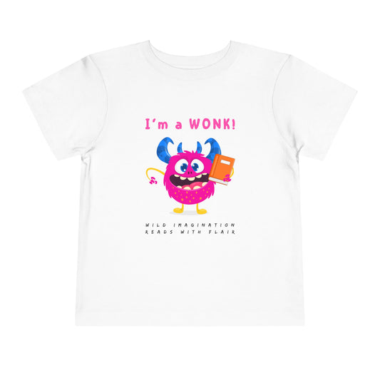 White toddler personality t-shirt with a cartoon monster holding a book, proudly proclaiming 'I'm a WONK!' Sub-text 'Wild Imagination, Reads With Flair' on a white background