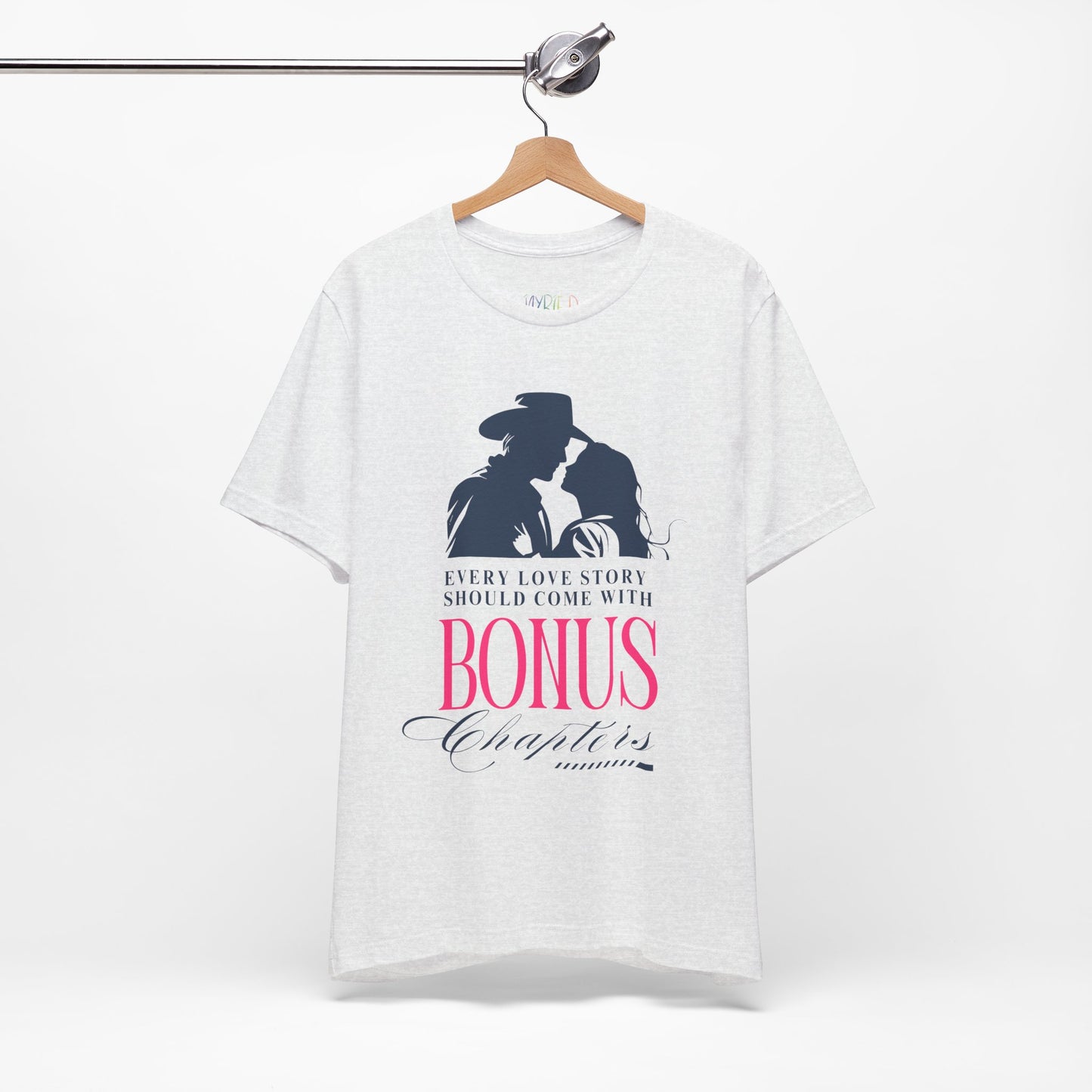 Ash t-shirt with western graphic of a man and woman leaning in for a kiss, text "Every Love Story Should Come With BONUS Chapters'