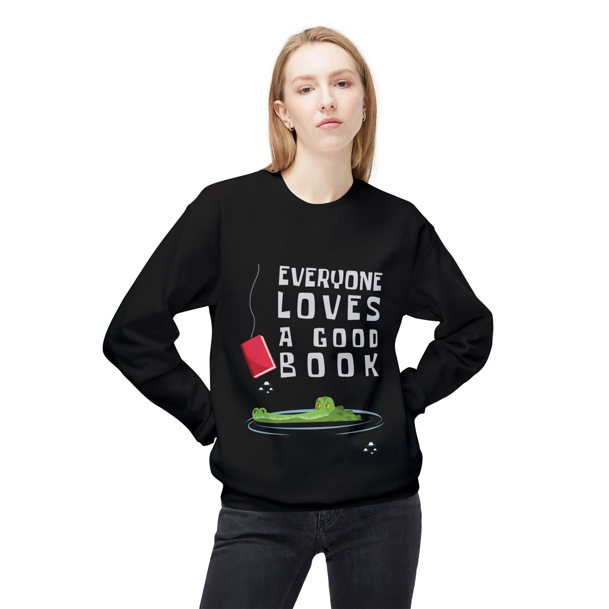 Woman wearing a  black sweatshirt with a book on a fishing hook, dangling in front of an alligator and text 'Everyone Loves a Good Book' 