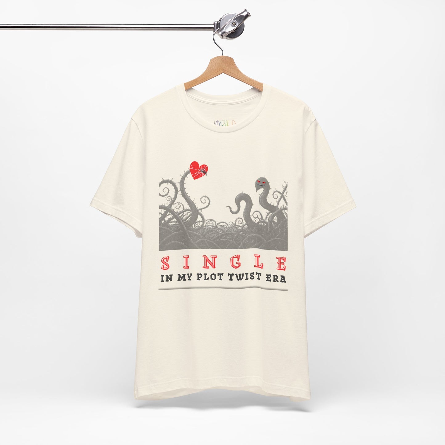 Beige t-shirt with thorny vines stabbed through a heart and text 'SINGLE. In My Plot Era' 