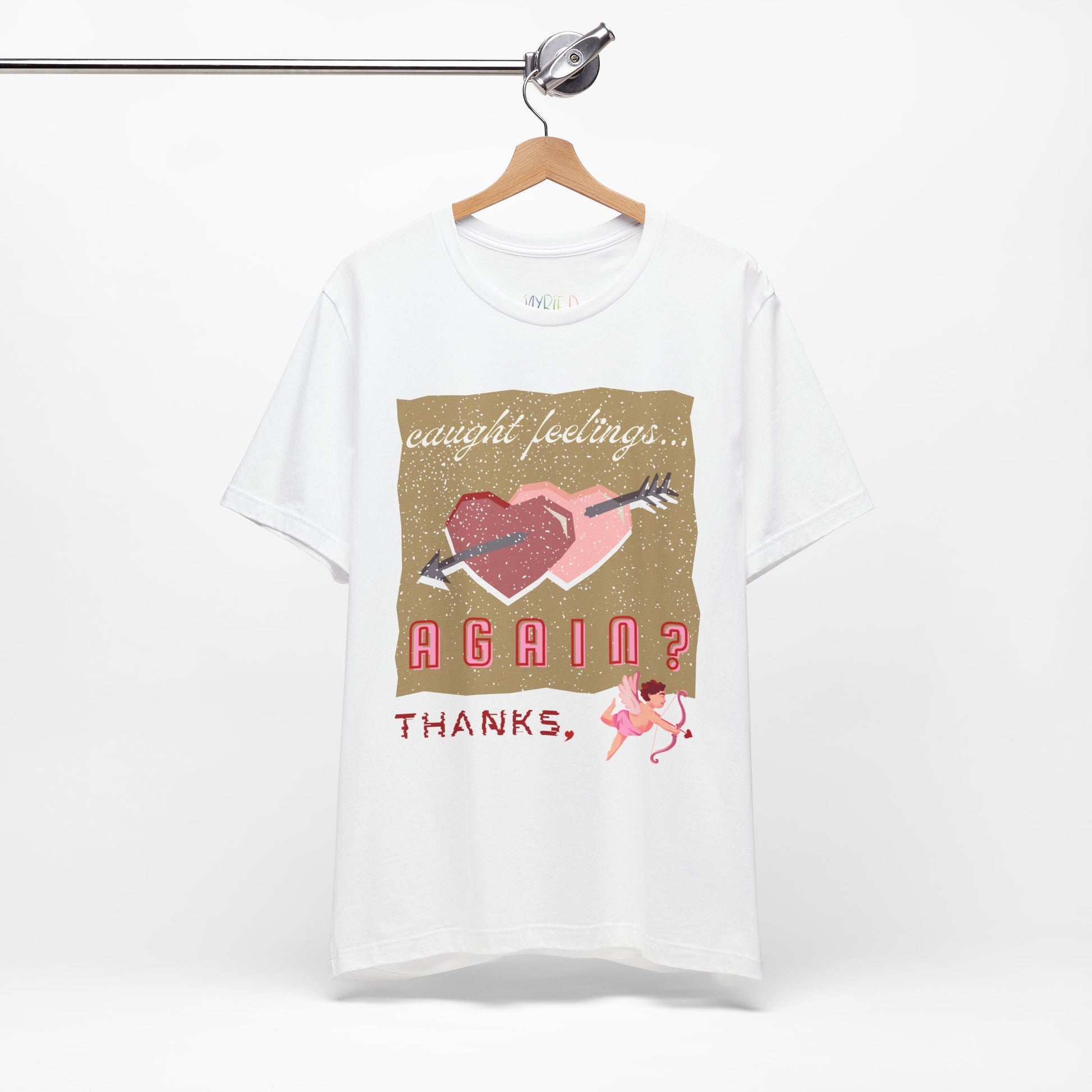 Whitet-shirt with double heart graphic design and text 'Caught Feelings AGAIN? Thanks,' followed by a picture of cupid