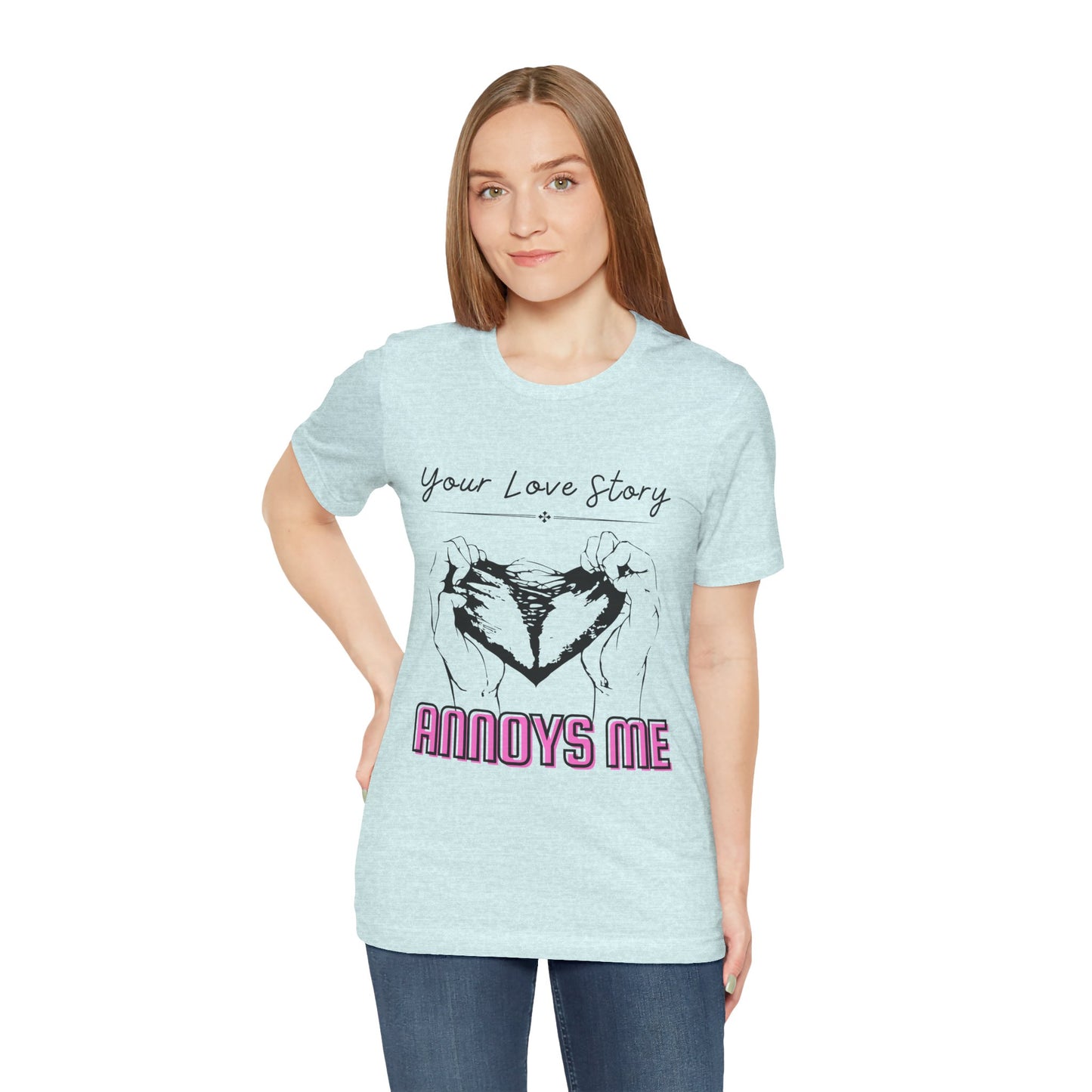 Woman wearing an icy blue t-shirt with graphic design of two hands pulling apart a heart and text 'Your Love Story ANNOYS ME'