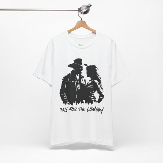White t-shirt with black graphic of a man and a woman, text says 'Fell for the Cowboy'