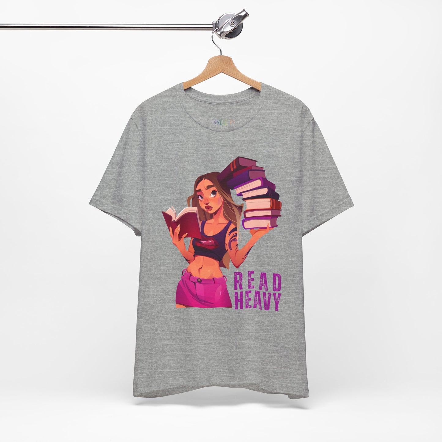 Gray t-shirt with a stylish woman graphic reading a book in one hand and holding a stack of books in the other, and the text 'Read Heavy' 