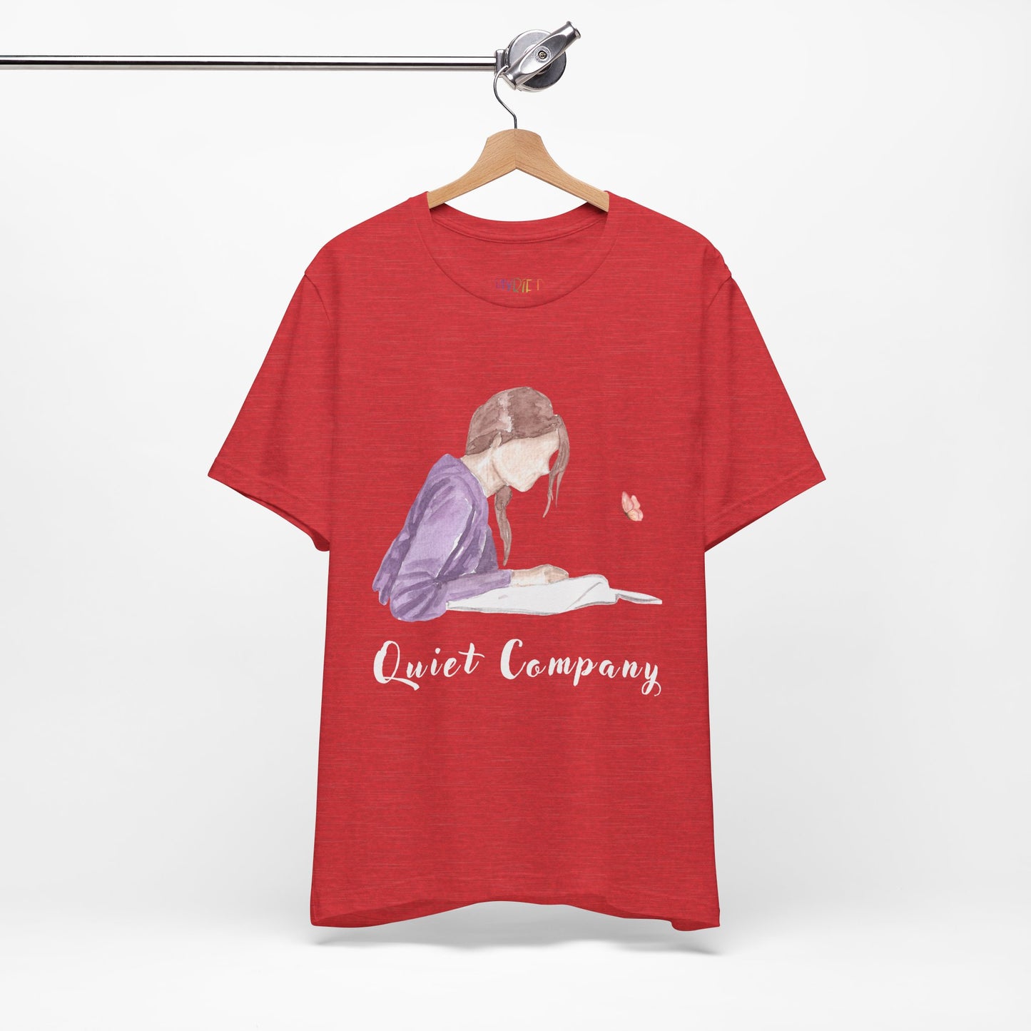 Red t-shirt with a graphic of a girl reading a book and the text 'Quiet Company' 