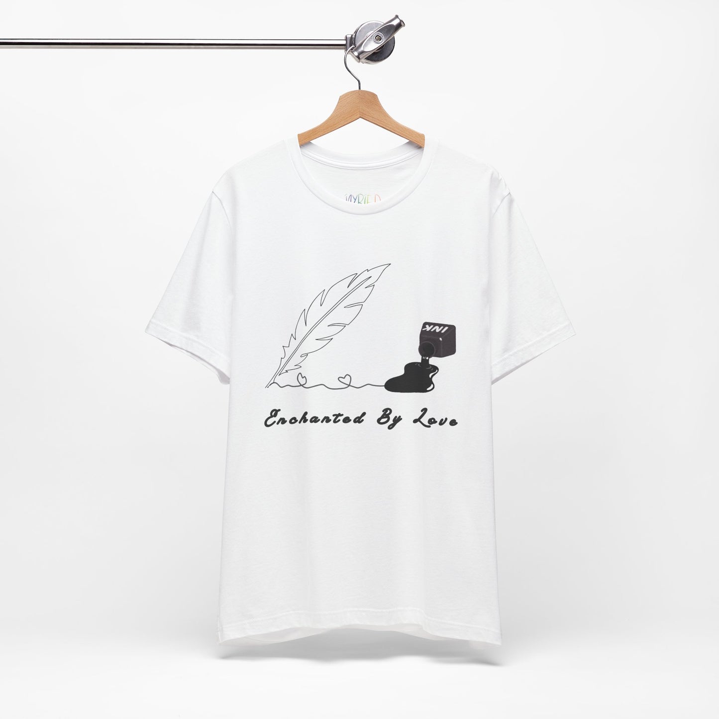 White t-shirt with a black sketched feather quill, spilled ink and text 'Enchanted By Love'