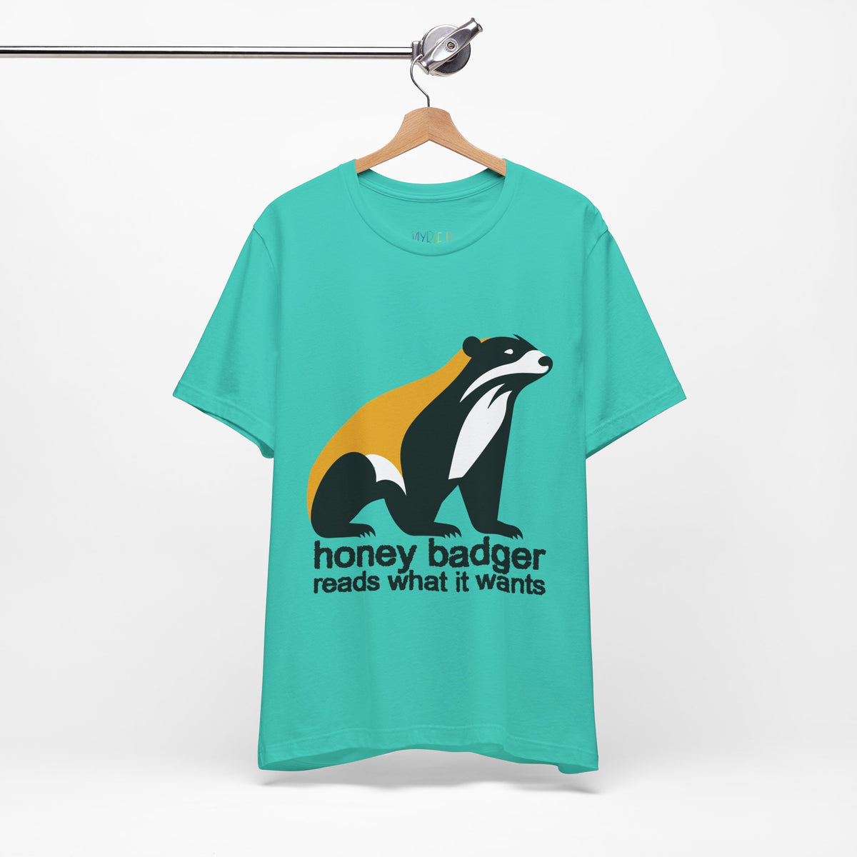 Teal green t-shirt featuring a large black yellow and white badger with text "honey badger reads what it wants"