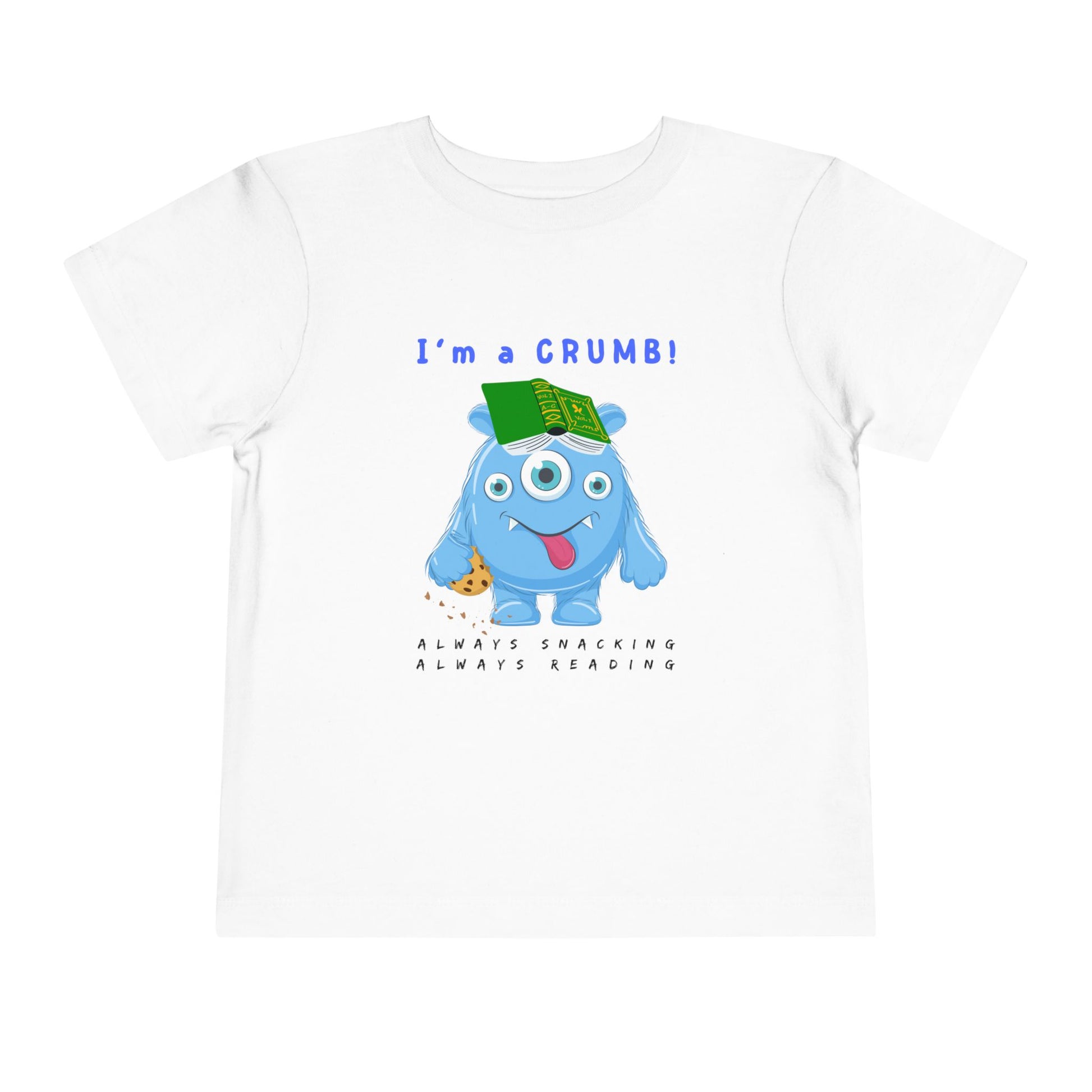 White toddler personality t-shirt with a blue cartoon monster eating a cookie and wearing a book on it's head, proudly proclaiming 'I'm A Crumb!' Sub-text 'Always Snacking, Always Reading' on a white background