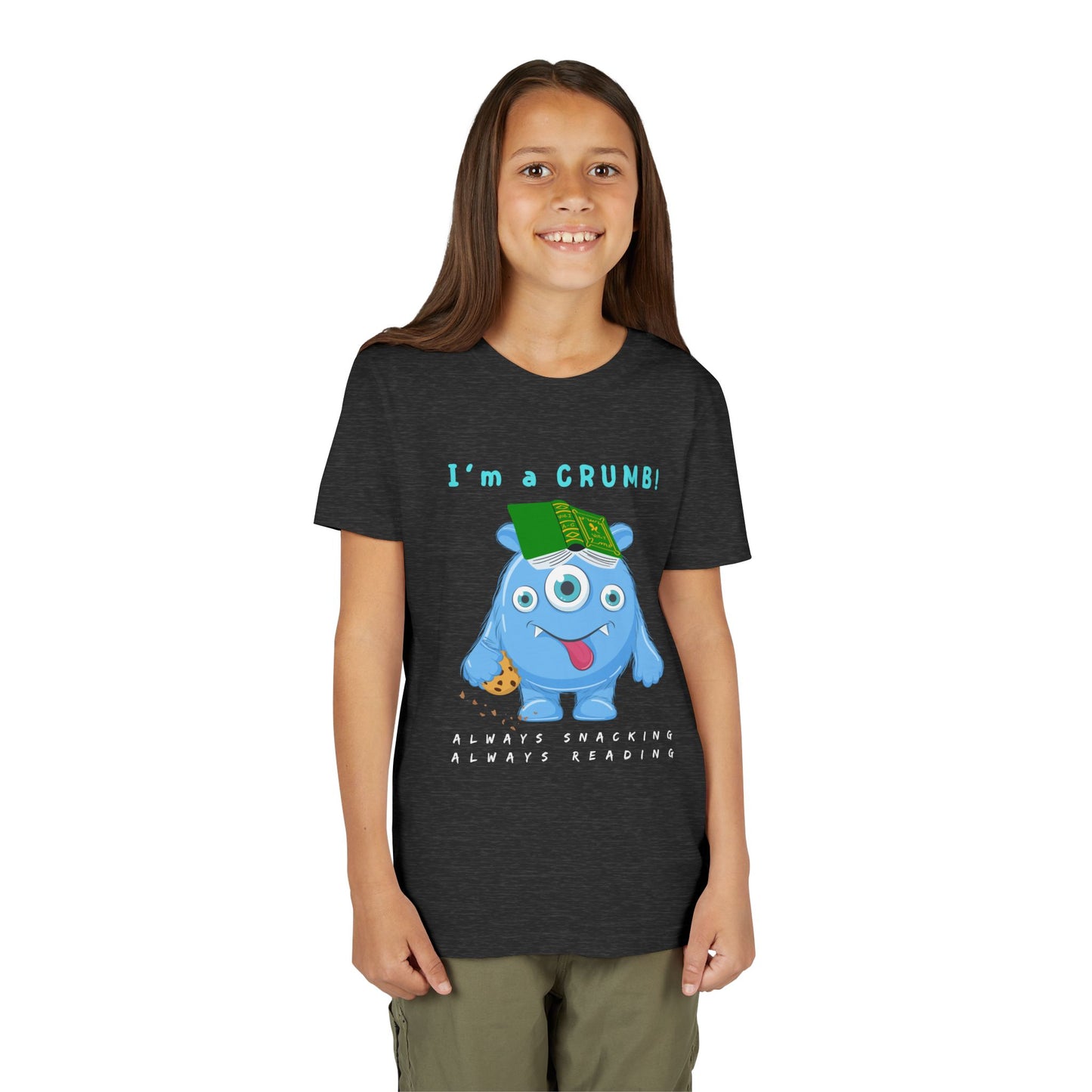 Girl wearing a dark t-shirt with a cartoon blue monster holding a book and text 'I'm a CRUMB!'