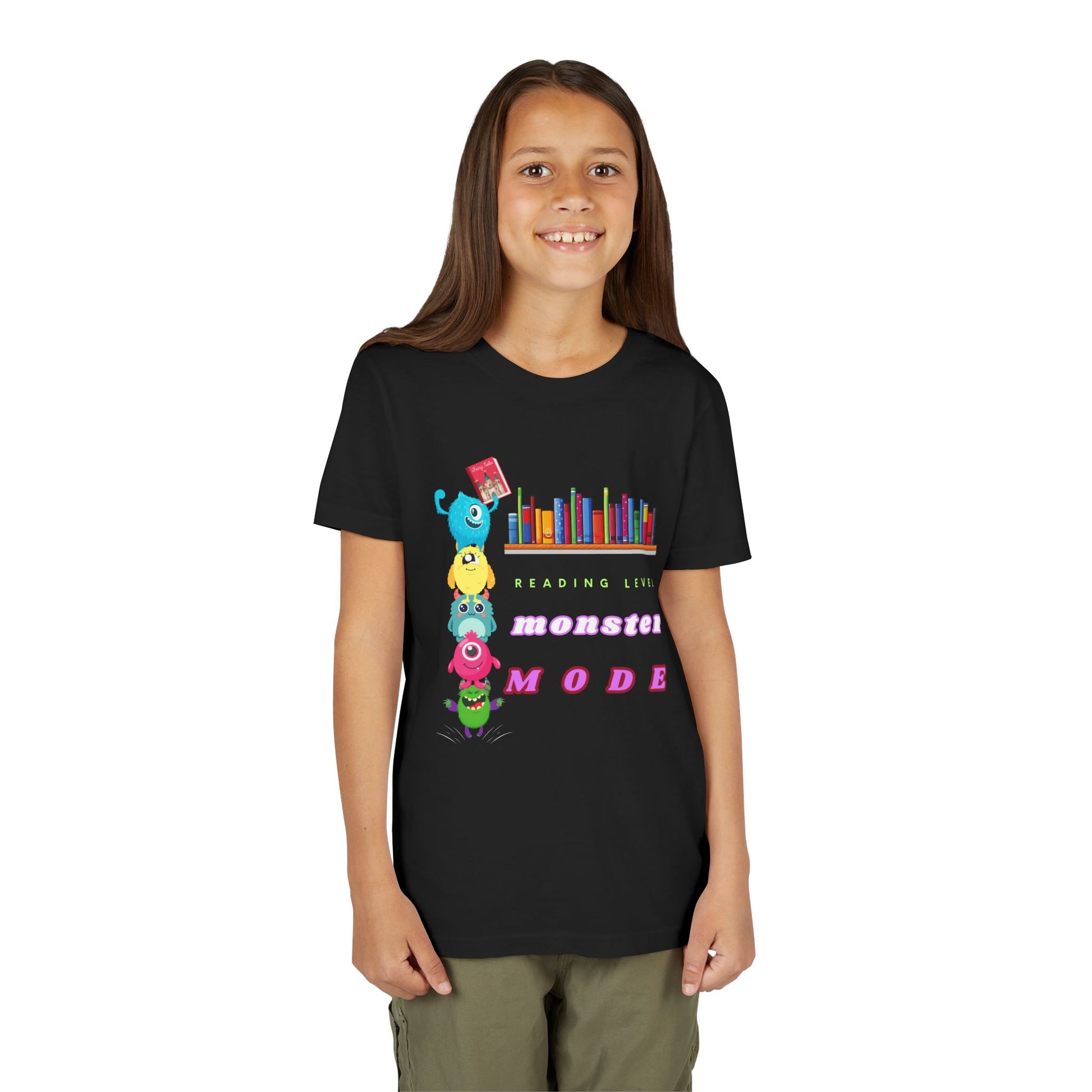 Girl wearing a black t-shirt with colorful monsters standing on each others shoulders to reach a book on the bookshelf and text 'Reading Level Monster Mode'