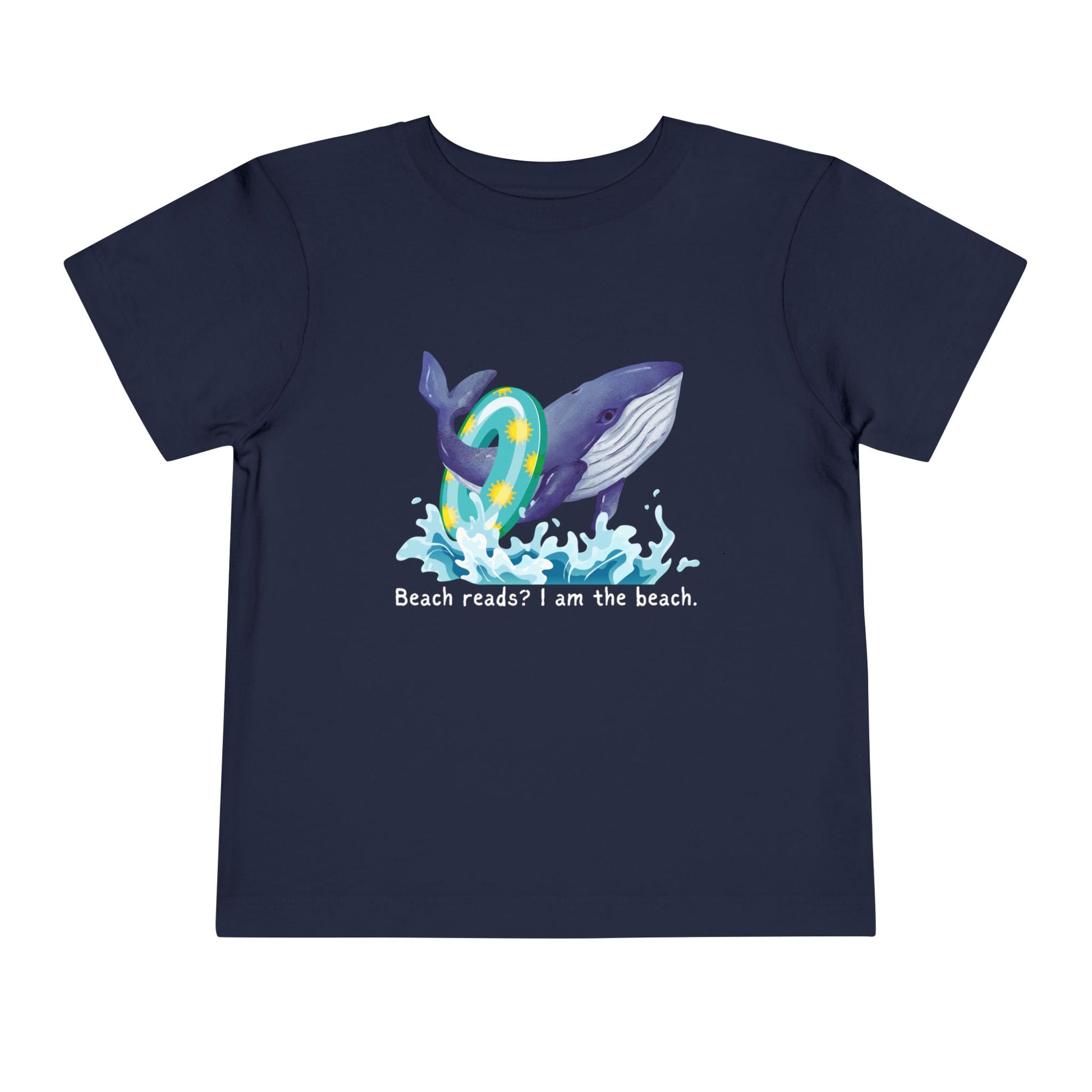 Navy blue toddler t-shirt with a whale graphic jumping out of the water with a pool floatie and text 'Beach reads? I am the beach.' 