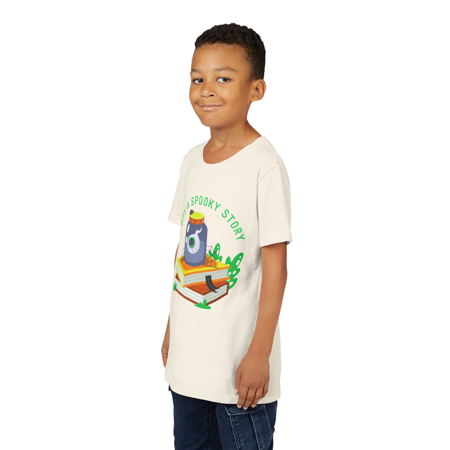 Boy wearing a beige t-shirt with a graphic design of a jar with an eyeball, books, a spider and text 'I Spy A Spooky Story'