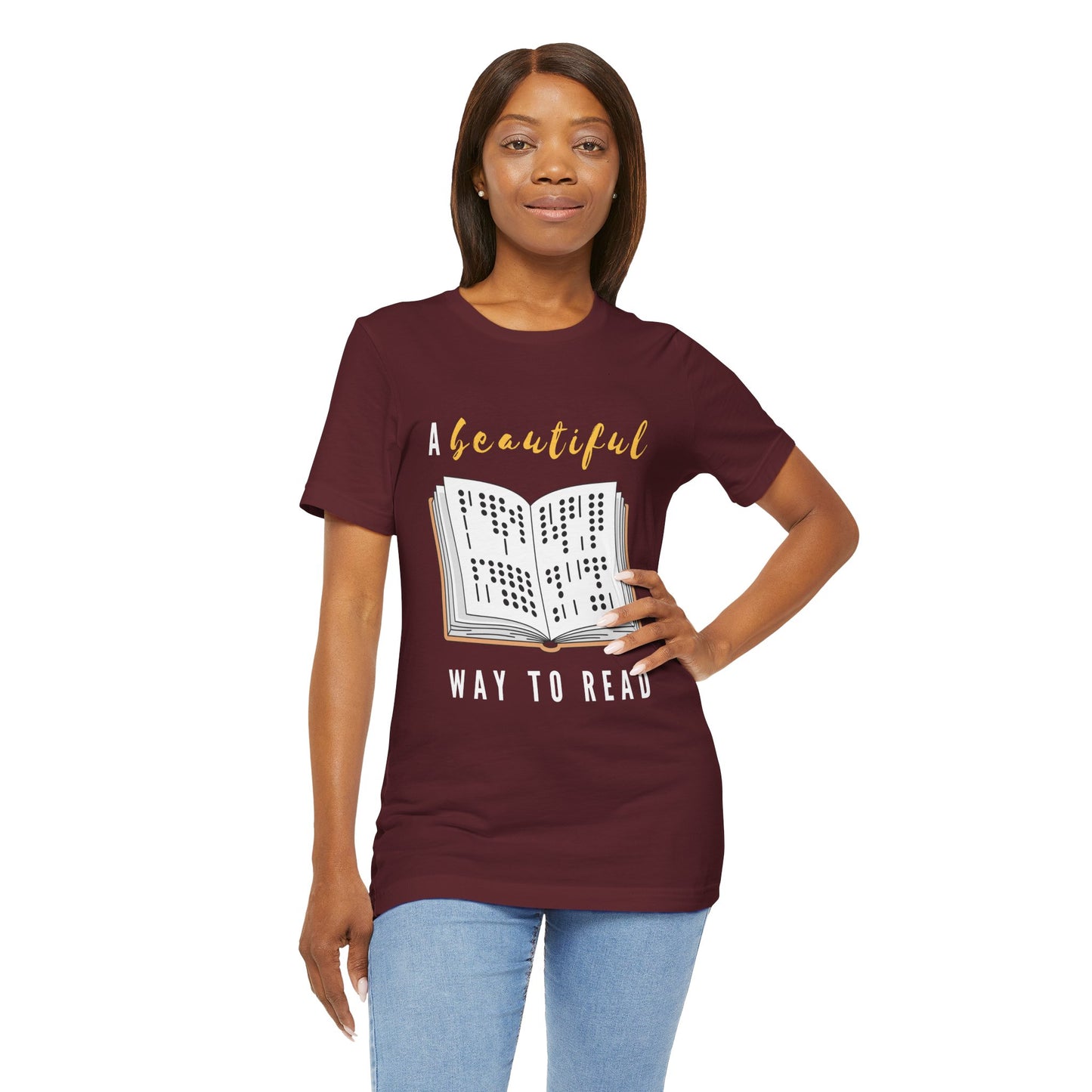 Woman wearing a maroon t-shirt with graphic design of a book in braille and text 'A Beautiful Way to Read'