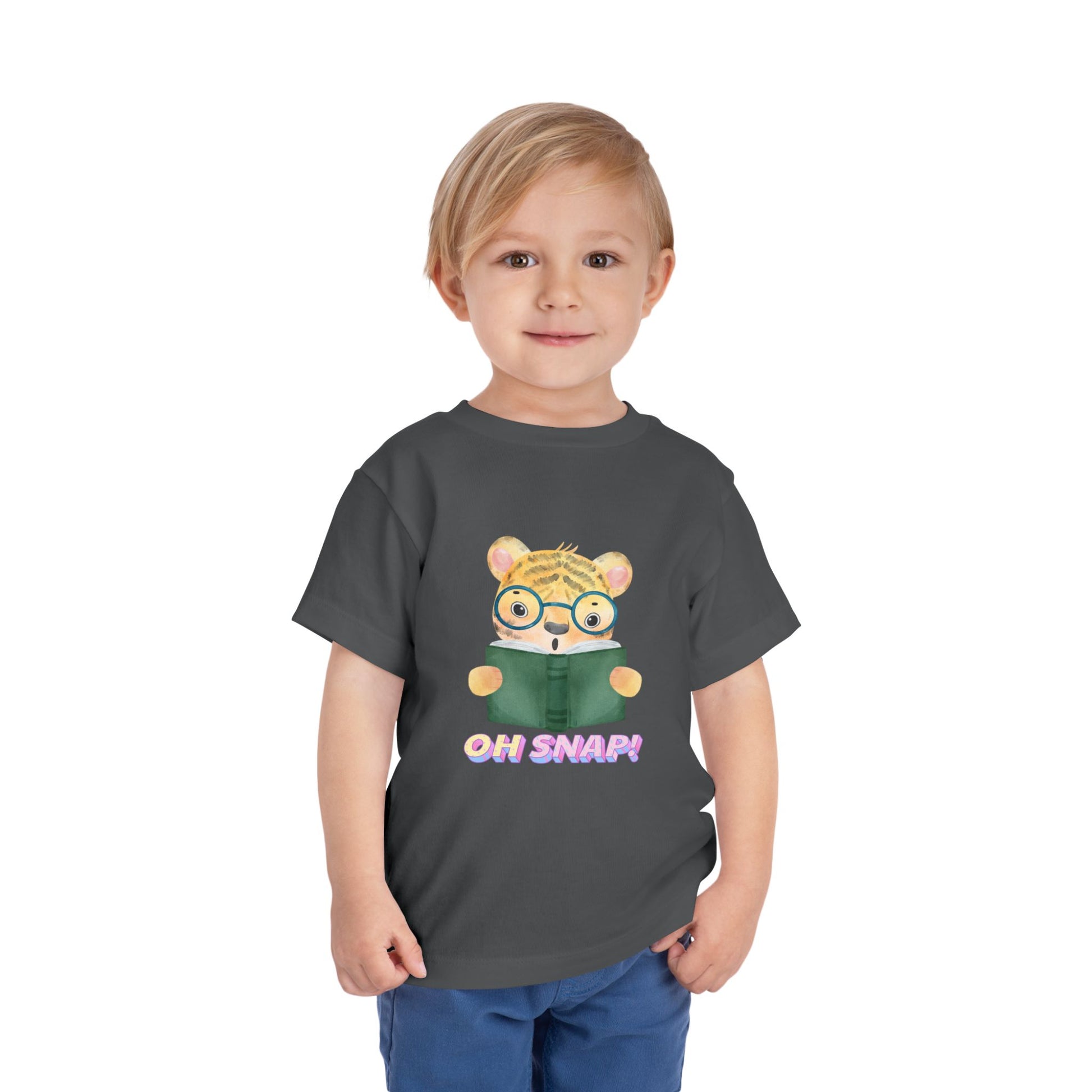 Child wearing a gray toddler t-shirt with a surprised cartoon tiger wearing glasses, holding a book and text 'OH SNAP!' 