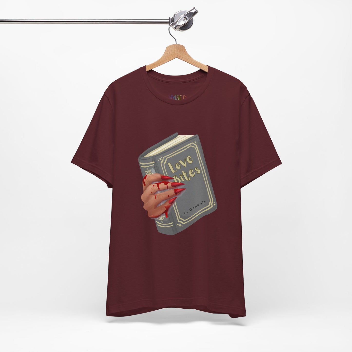 Maroon t-shirt with graphic design of a creepy and bloody hand holding a book titled 'Love Bites' by C. Dracula